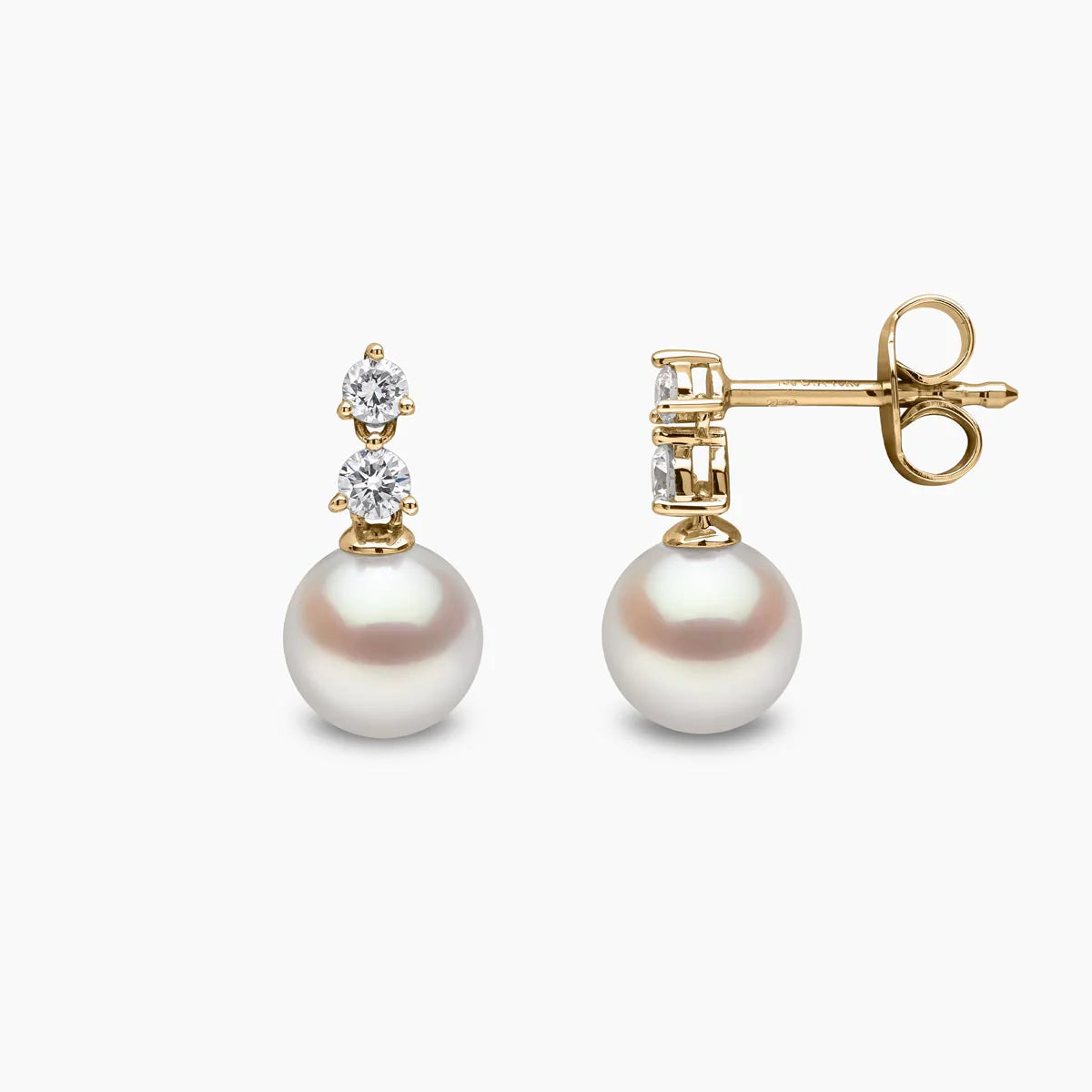 Yellow gold pearl and diamond drop earrings on grey background, side and front view