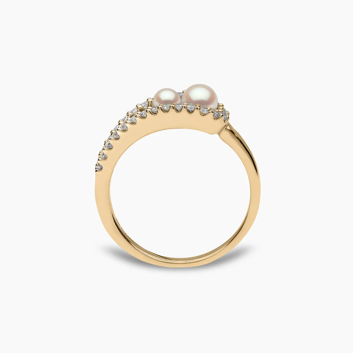 Yellow gold fashion ring with two white pearls and diamond accents on grey background, side view