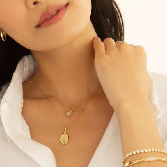 Woman wears 18K yellow gold locket necklace