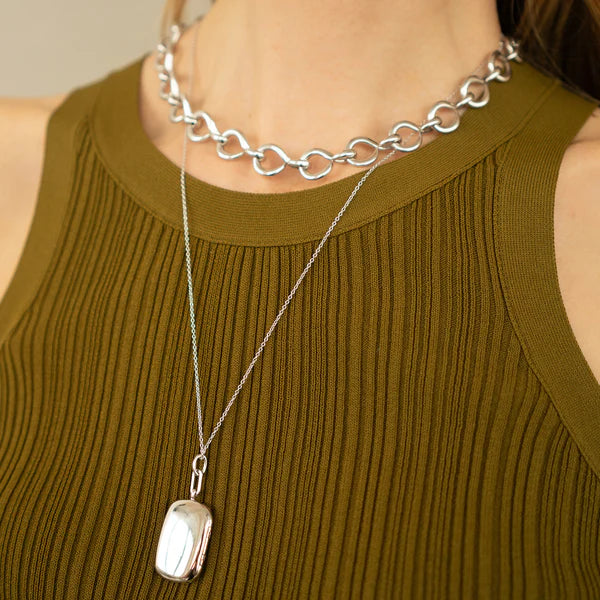 Woman wears sterling silver locket necklace