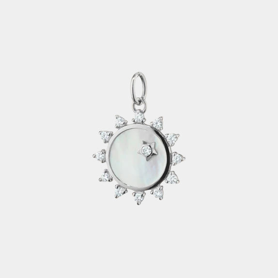 Sterling silver white mother of pearl and white sapphire sun pendant on grey background