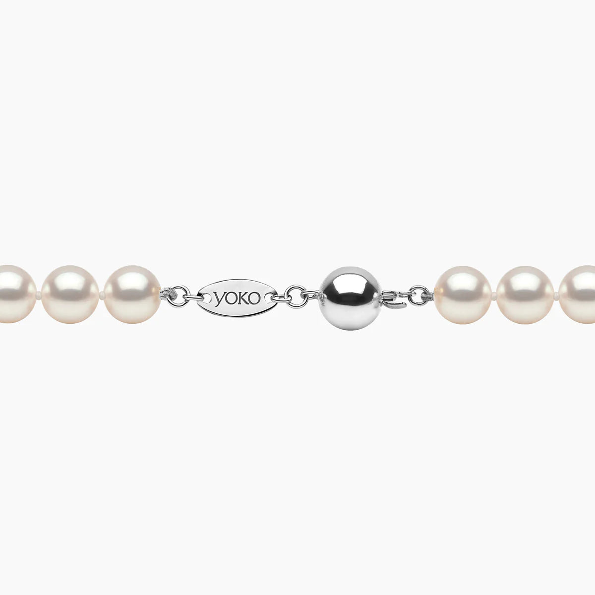 Pearl necklace with white gold clasp on a white background, featuring the Yoko London brand.