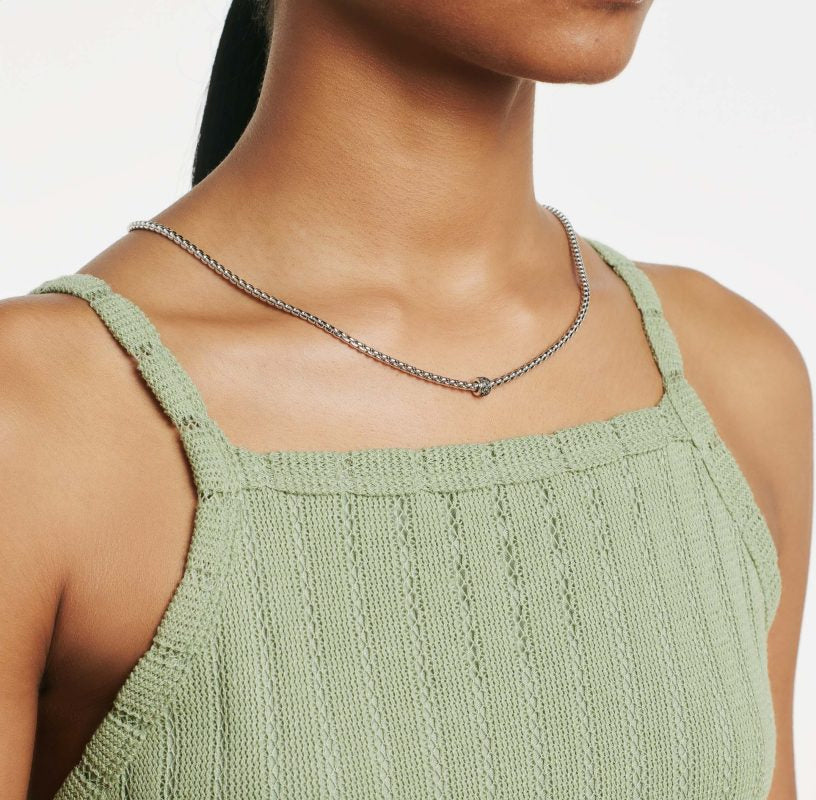 Woman wearing white gold diamond station necklace