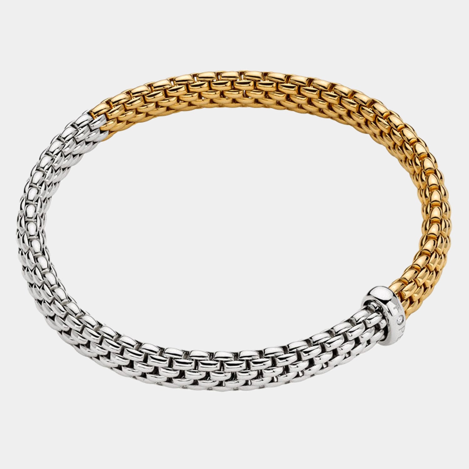 Two-toned silver and gold bracelet on a light gray background
