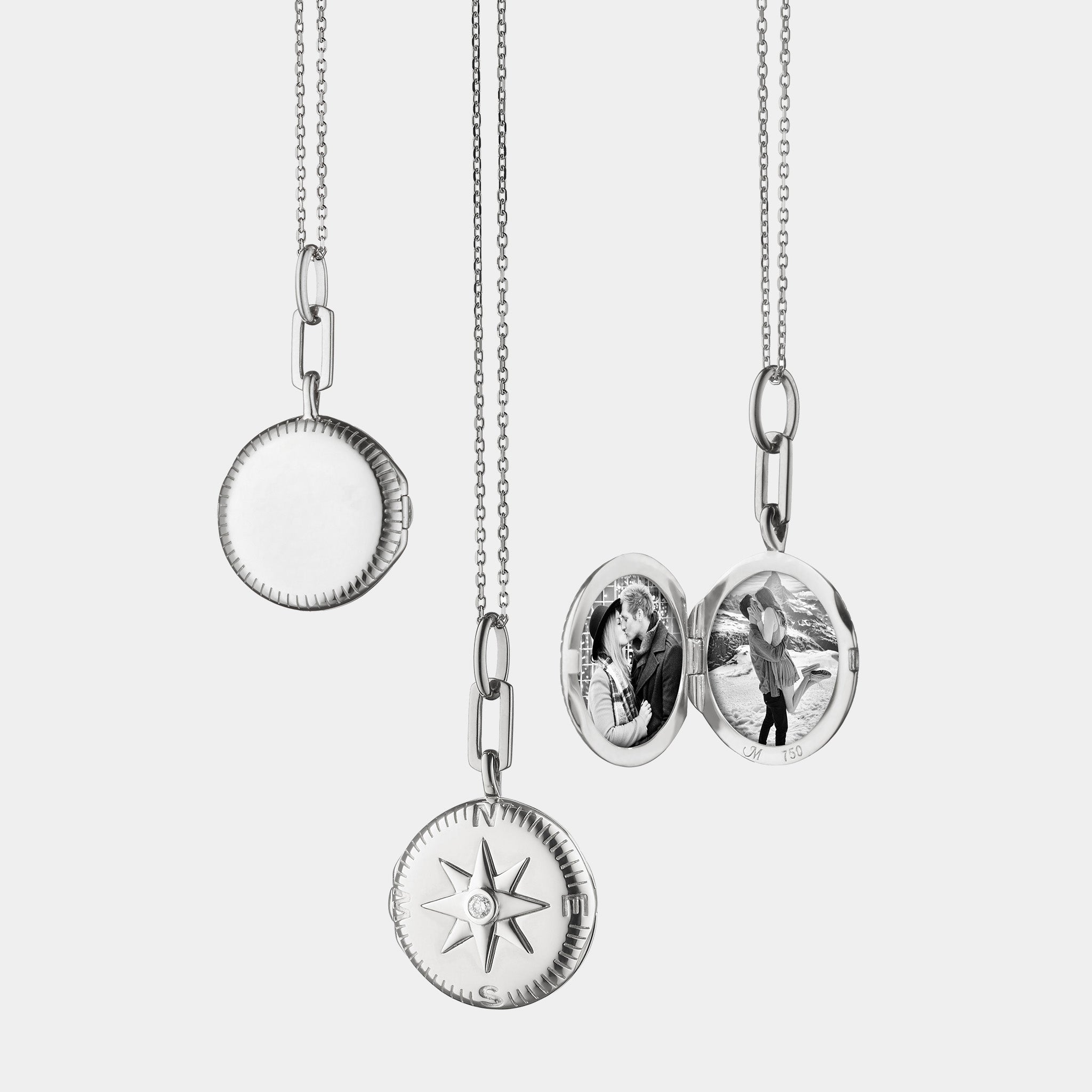 Silver pendant necklace with compass and two photos n grey background