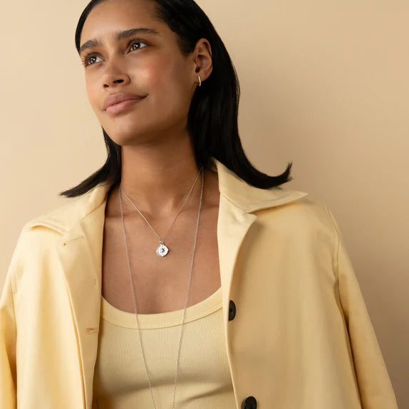 Woman wearing sterling silver compass pendant necklace