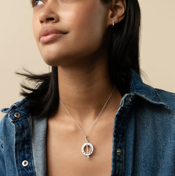 Woman wearing Sterling silver sundial rock crystal and white sapphire necklace