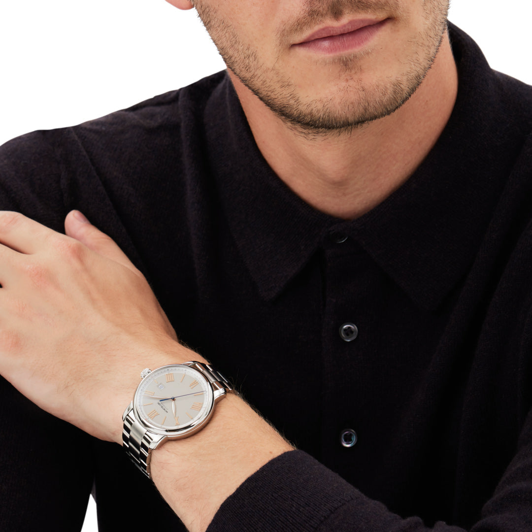 Man wearing a silver wristwatch on a white background