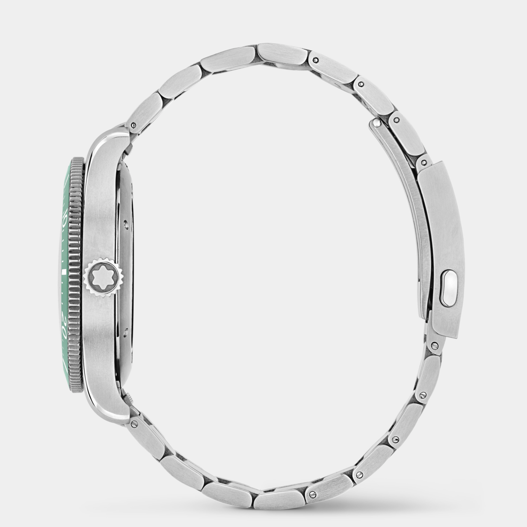 Close-up of a silver watch with a green face on a white background