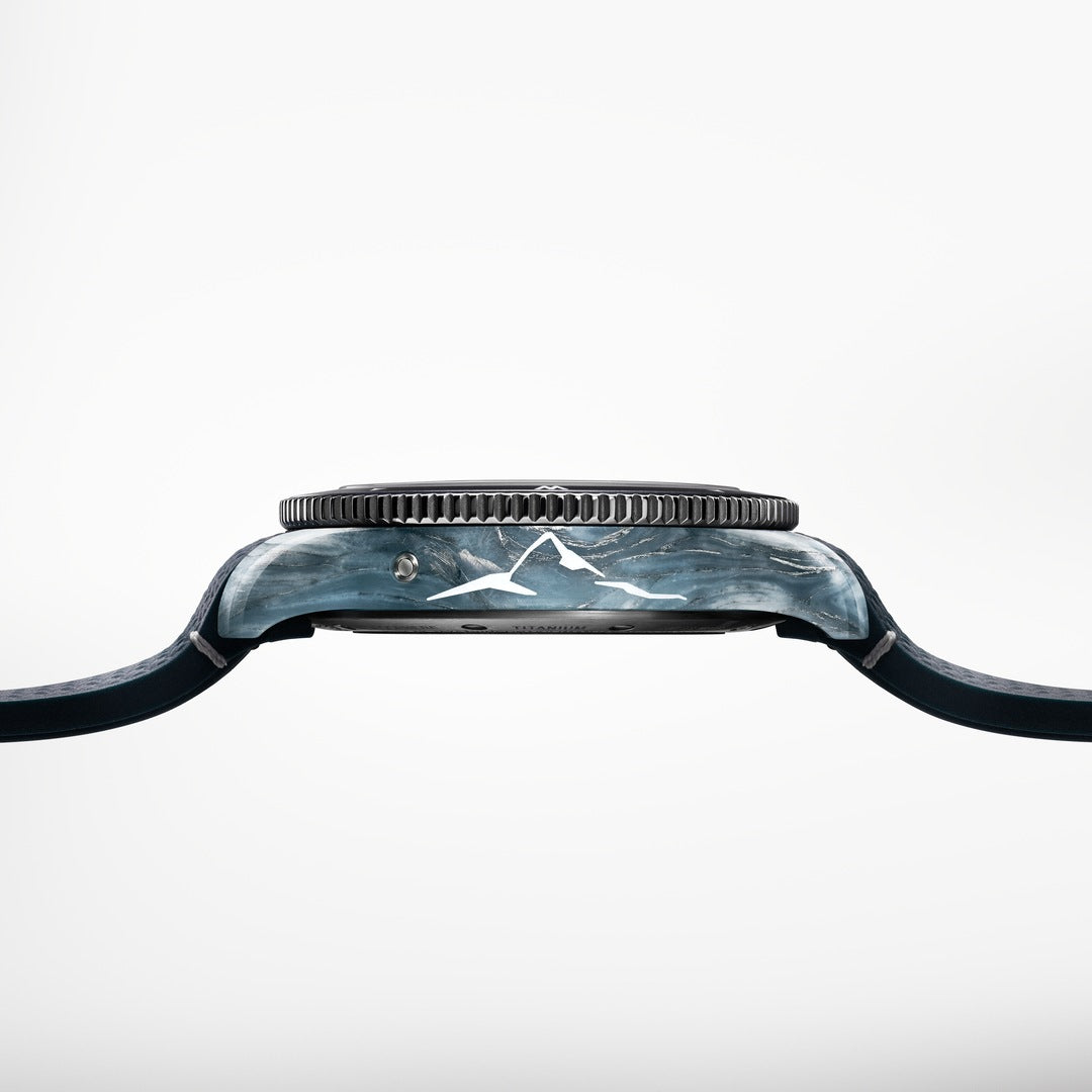 Close-up of a watch with a black strap and metallic case on a white background