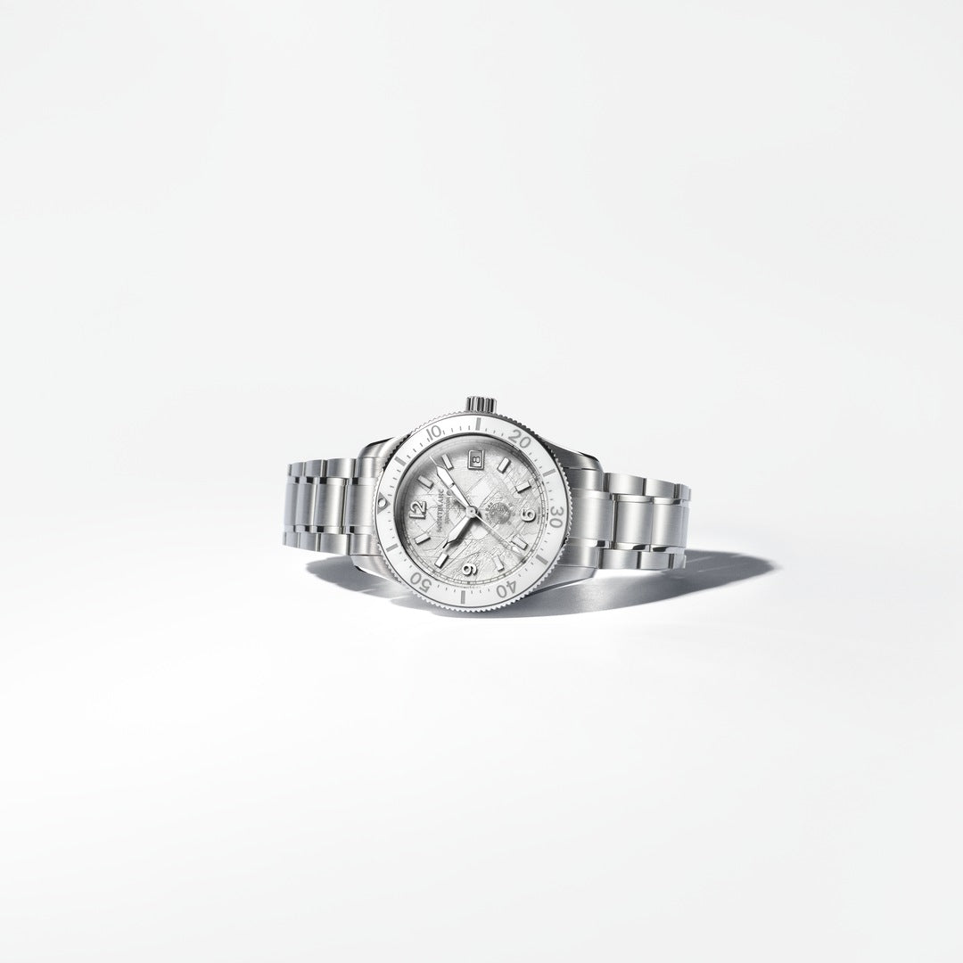 Silver watch with a white face on a light gray background