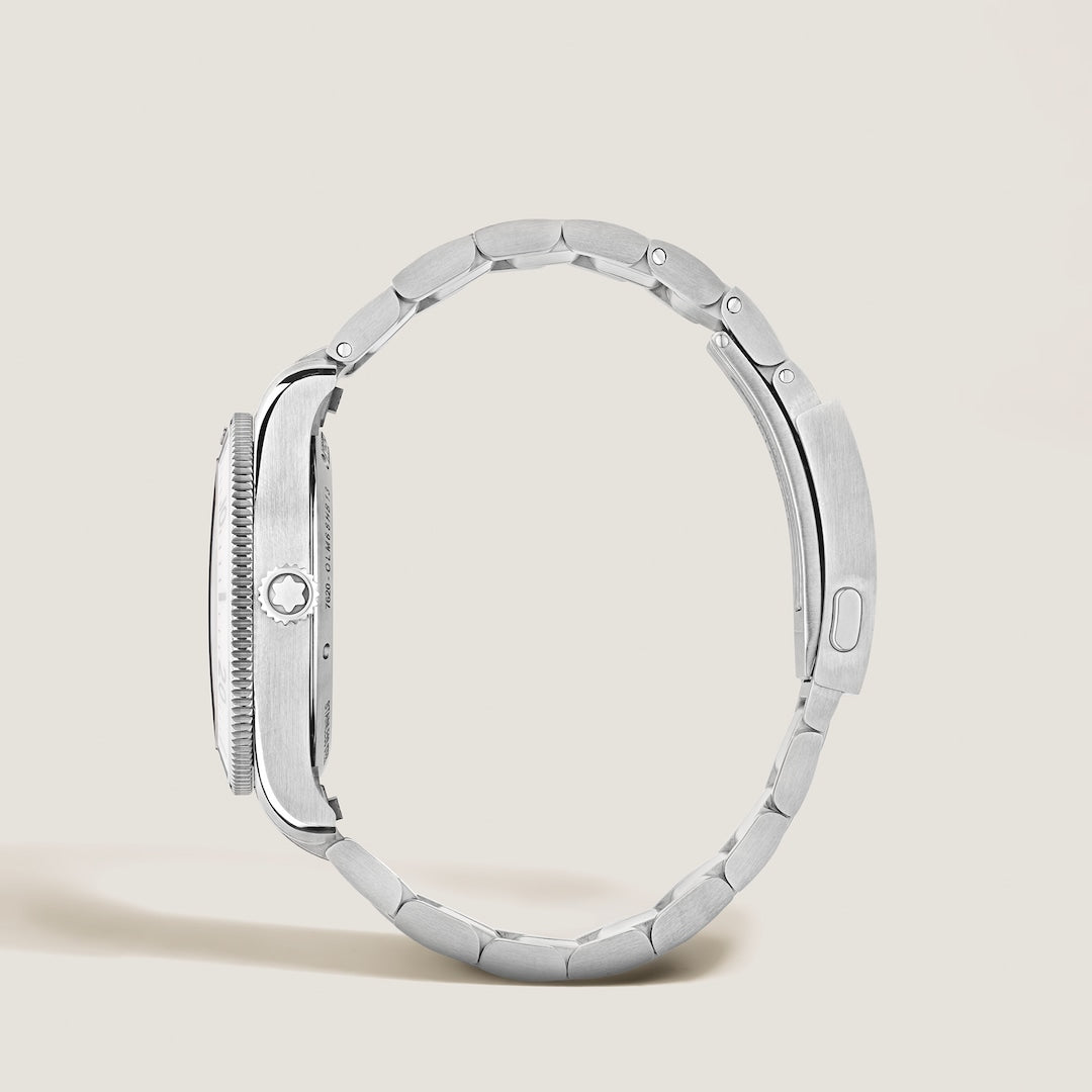 Silver watch case on a light beige background