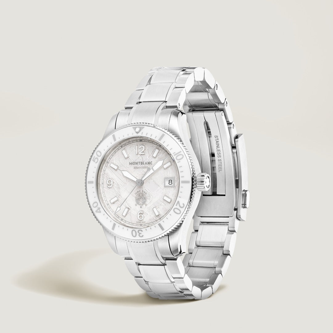 Silver watch with a detailed face on a light gray background