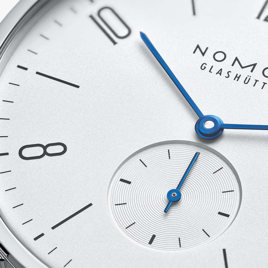NOMOS Glashütte Tangente 38mm watch with white dial, stainless steel case, and black leather strap on white background, sub dial view