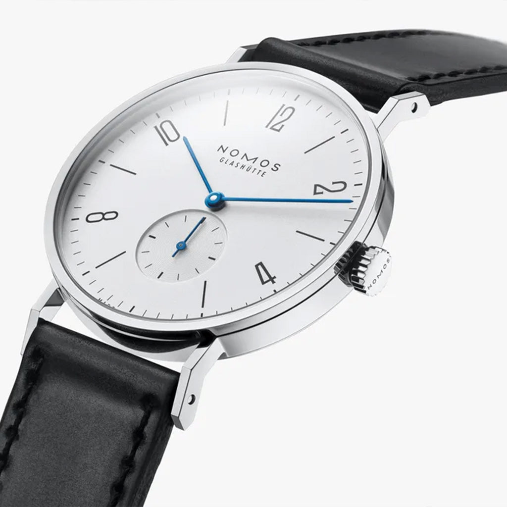 NOMOS Glashütte Tangente 38mm watch with white dial, stainless steel case, and black leather strap on white background