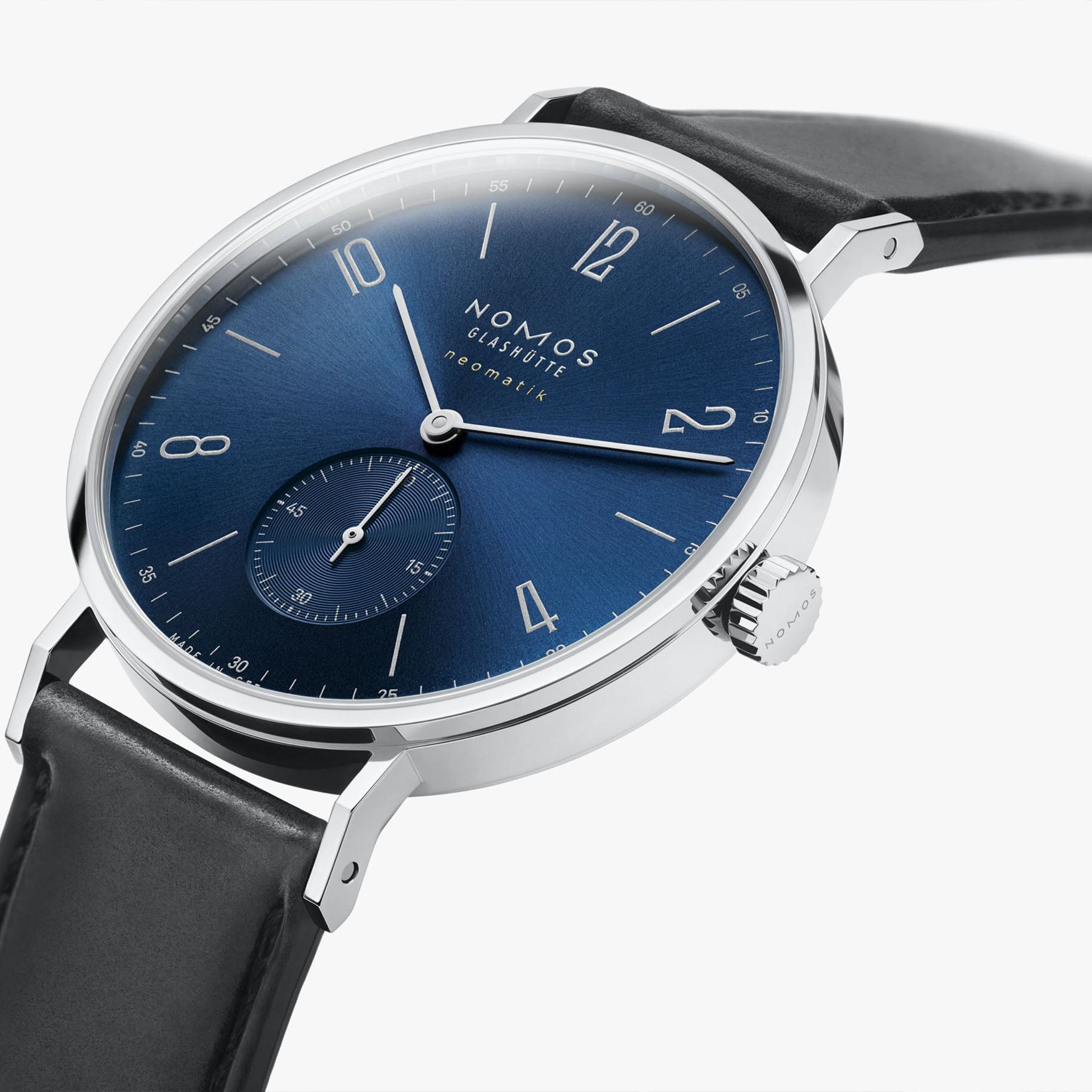 NOMOS Glashütte Tangente Neomatik Blue Gold 39mm automatic watch with blue sunburst dial, stainless steel case, and black leather strap on grey background, side angle view.