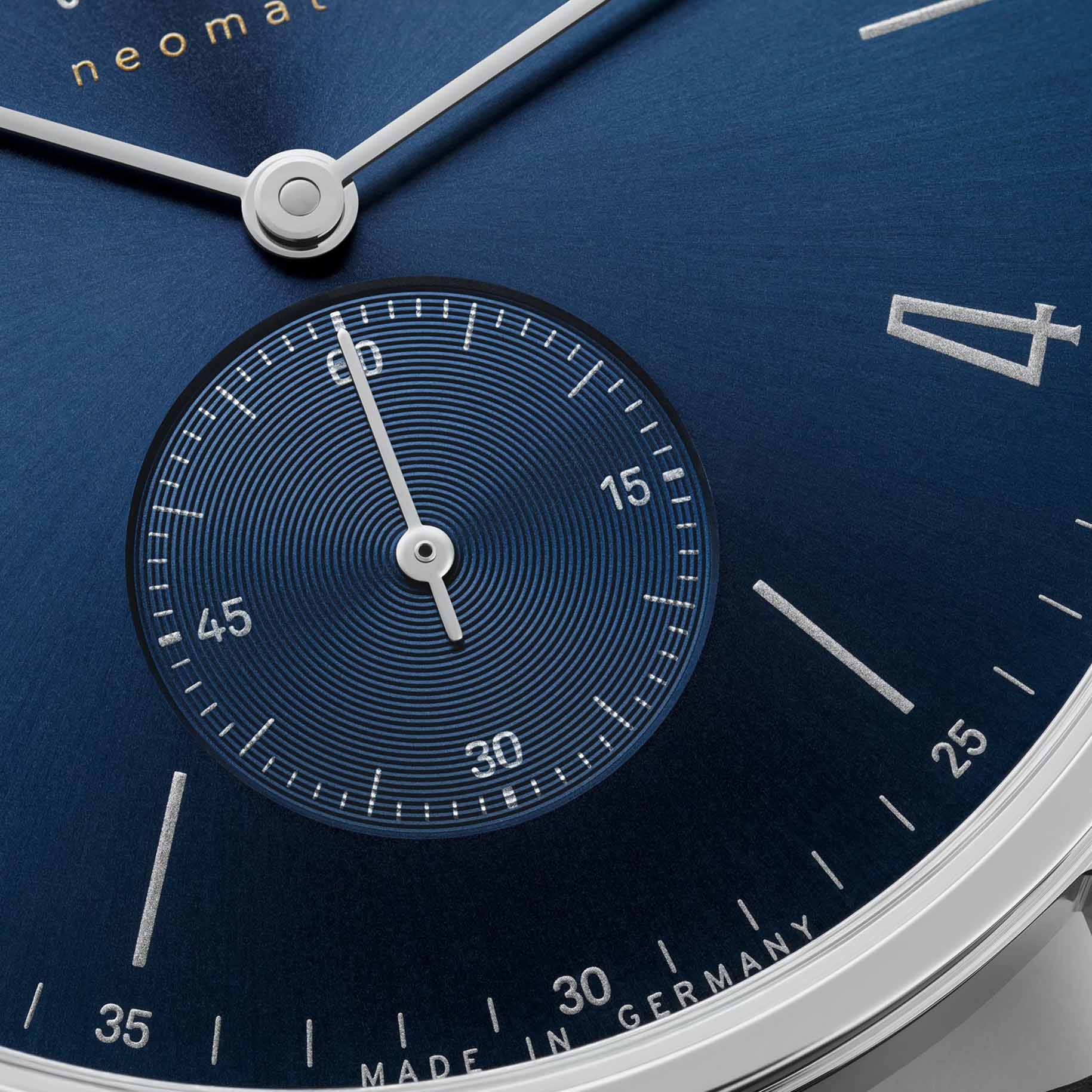 NOMOS Glashütte Tangente Neomatik Blue Gold 39mm automatic watch with blue sunburst dial, stainless steel case, and black leather strap on grey background, sub dial closeup
