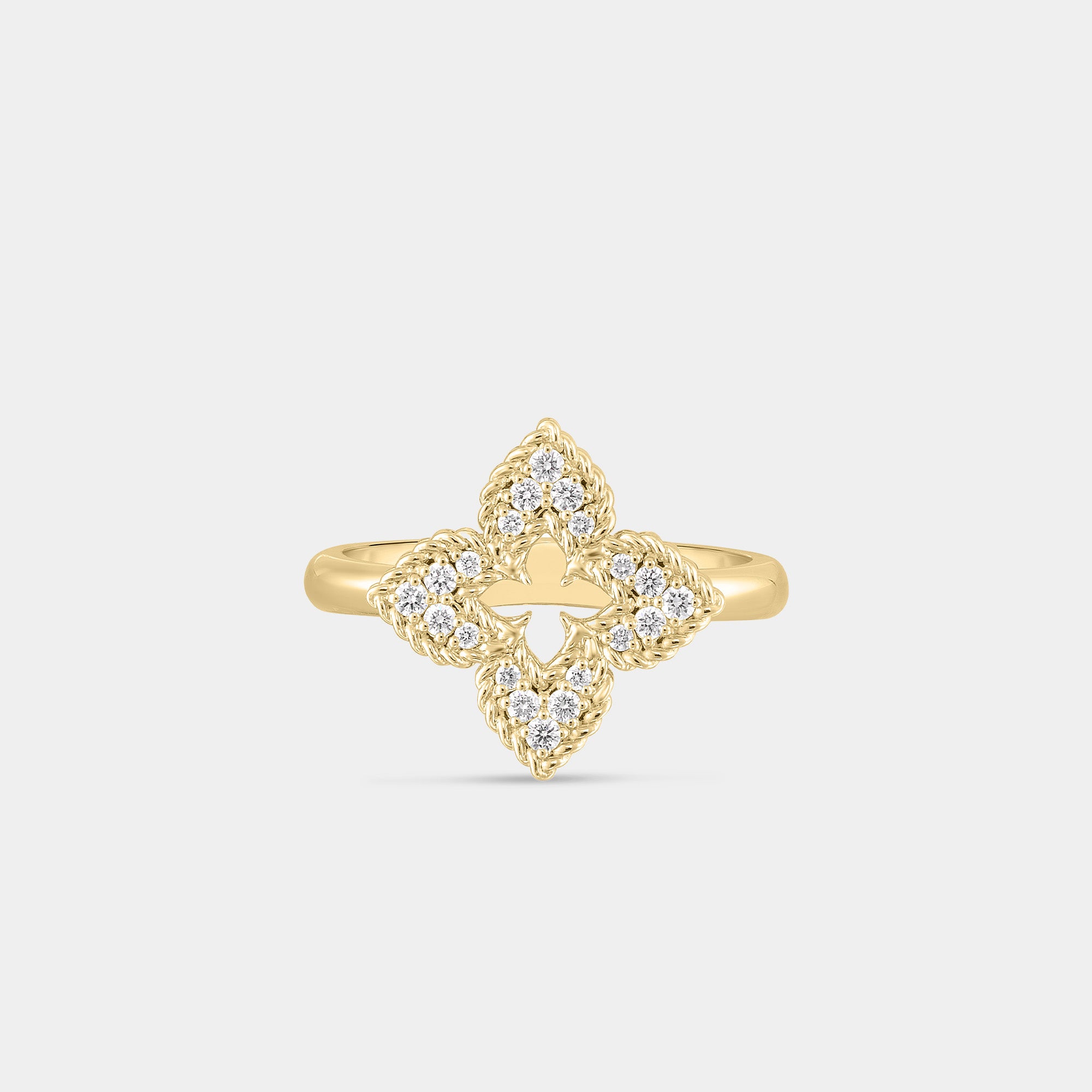 Yellow gold and diamond floral ring on gray background.