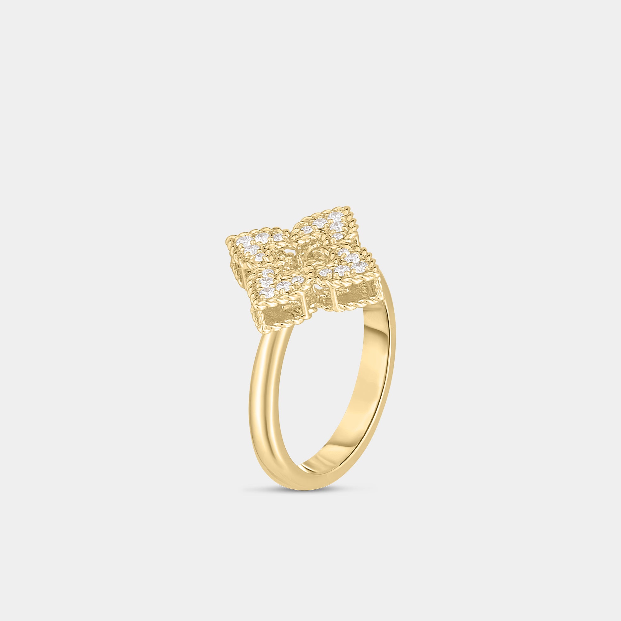 Yellow gold and diamond floral ring on gray background, side angle view.