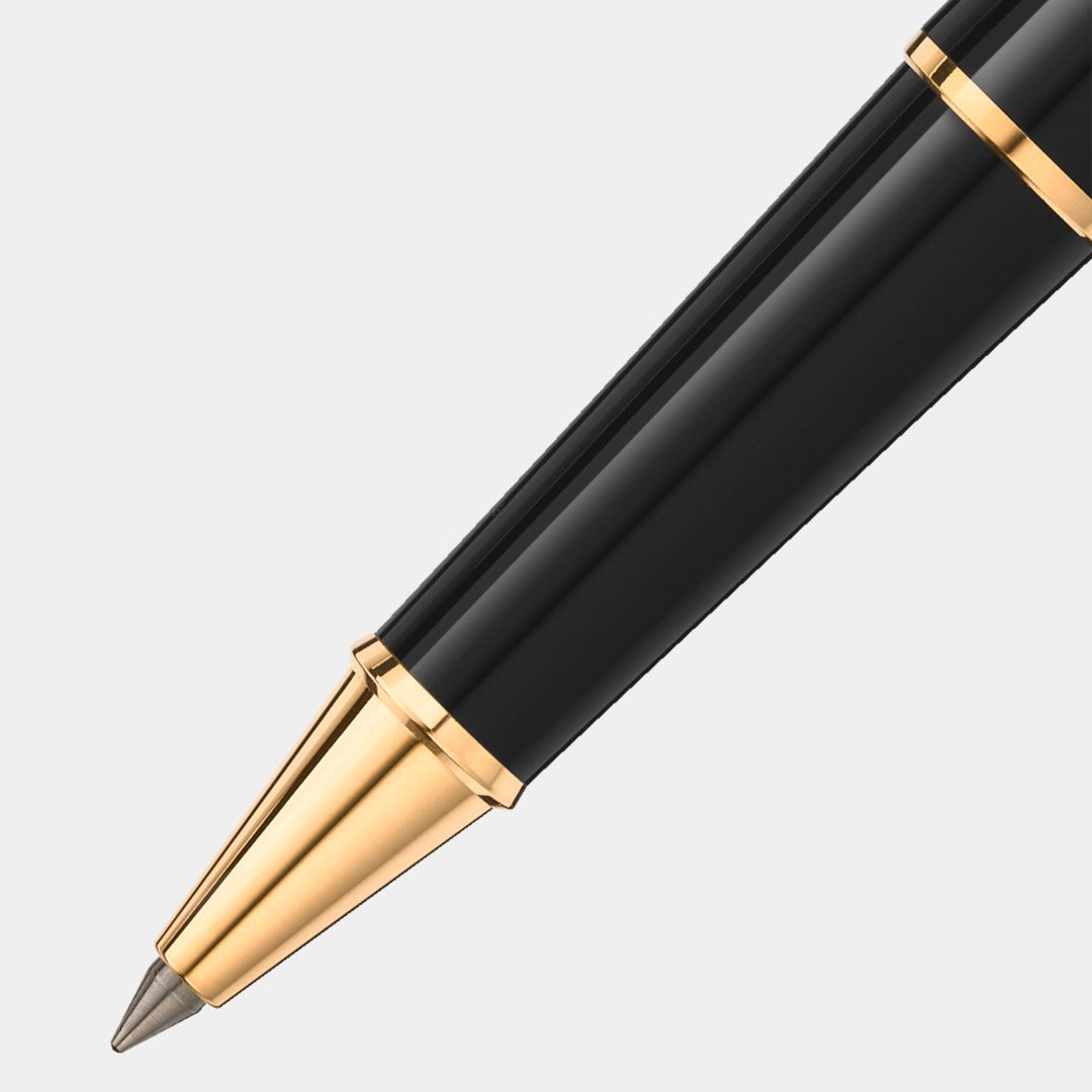 Black pen with gold accents on a light gray background