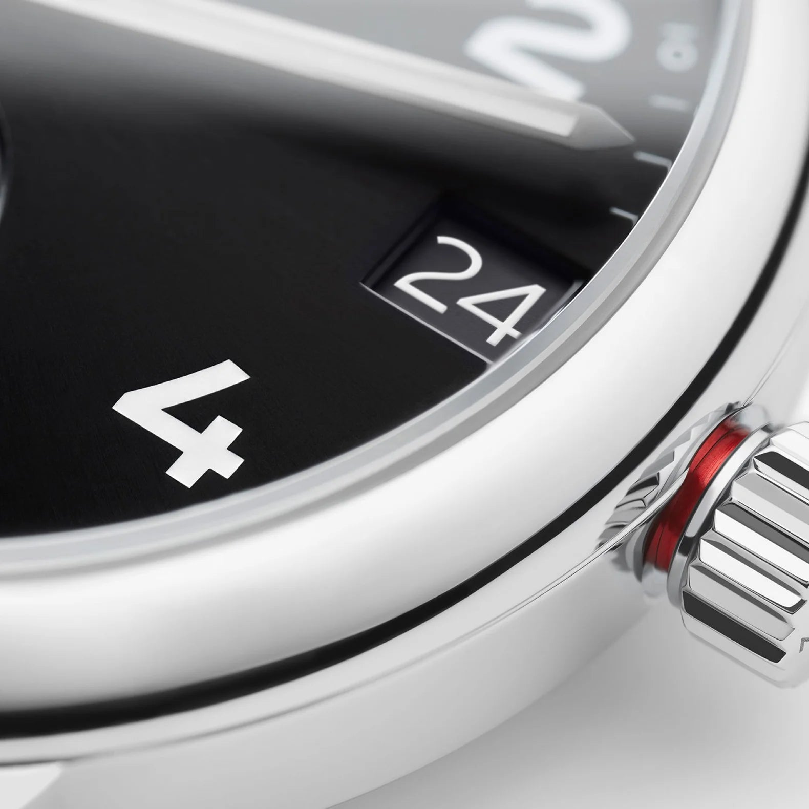 NOMOS Glashütte Club Sport Neomatik 42mm watch with black dial, closeup of screw down crown with red accents