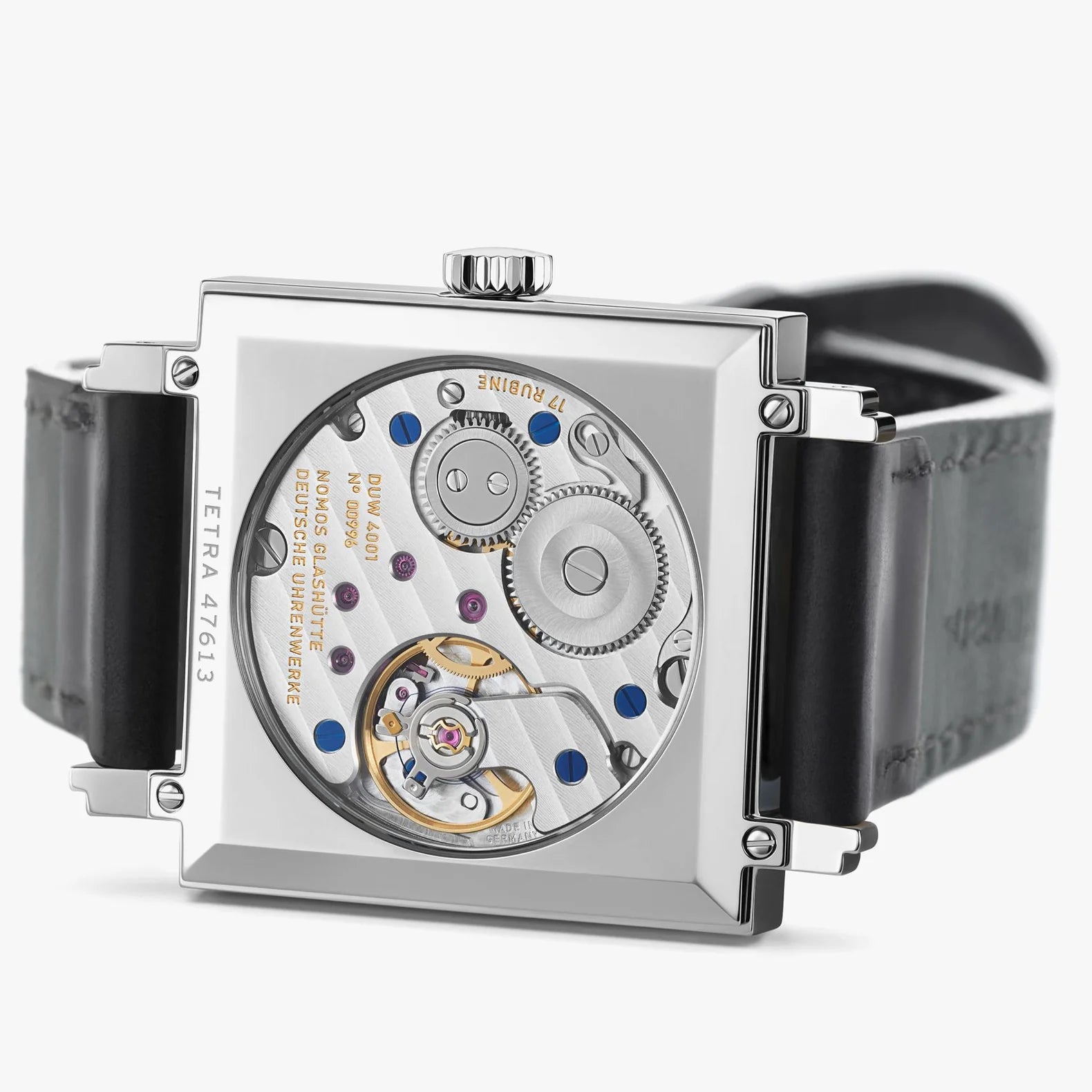 NOMOS Glashütte Tetra 29.5mm square watch with white dial, blue hands, and black Horween leather strap on white background, angled exhibition caseback view.