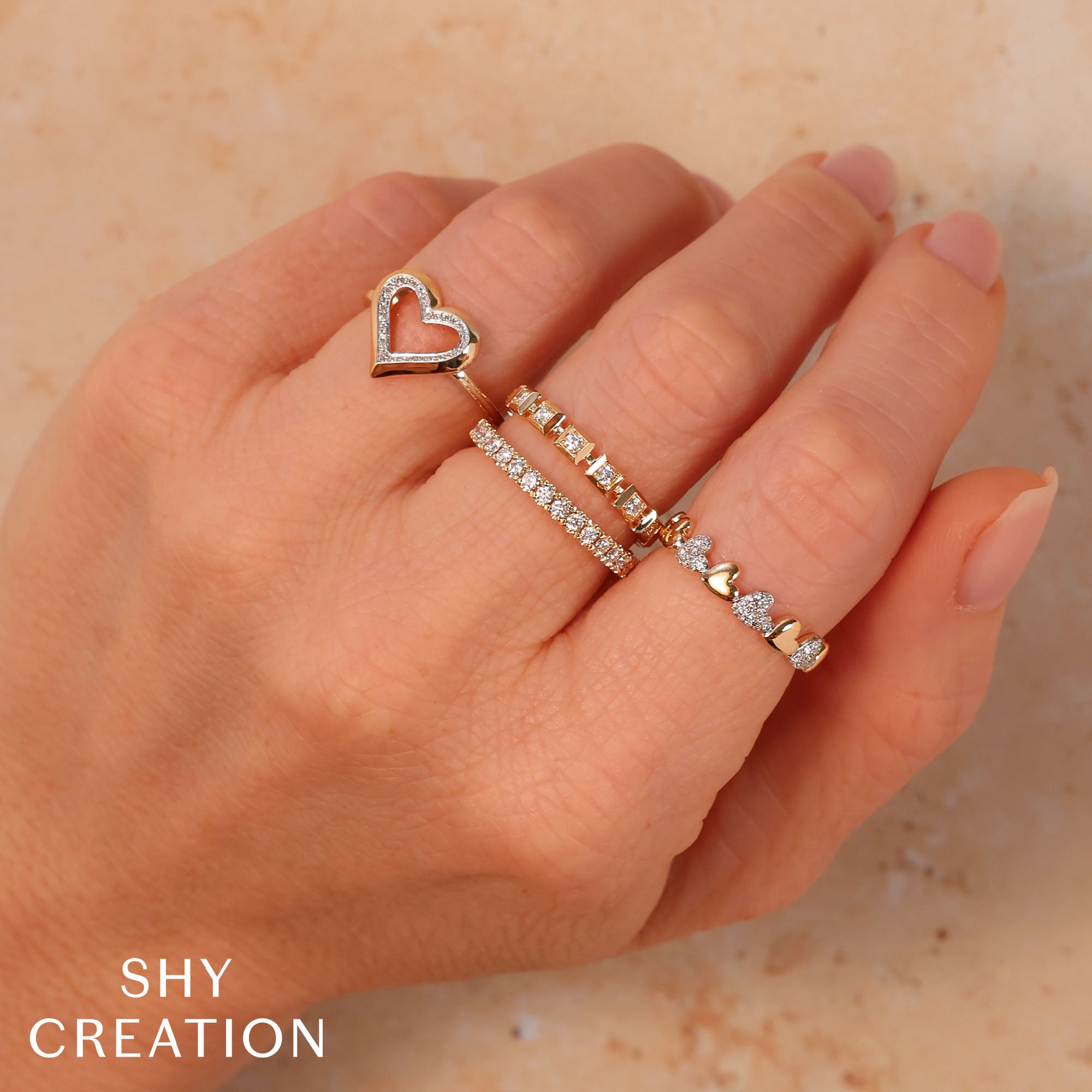 Woman wearing yellow gold diamond fashion ring with square bezel setting