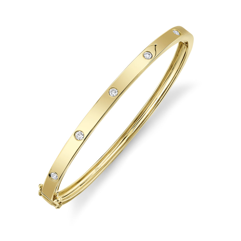 Yellow gold bezel set diamond bangle bracelet, side angle view