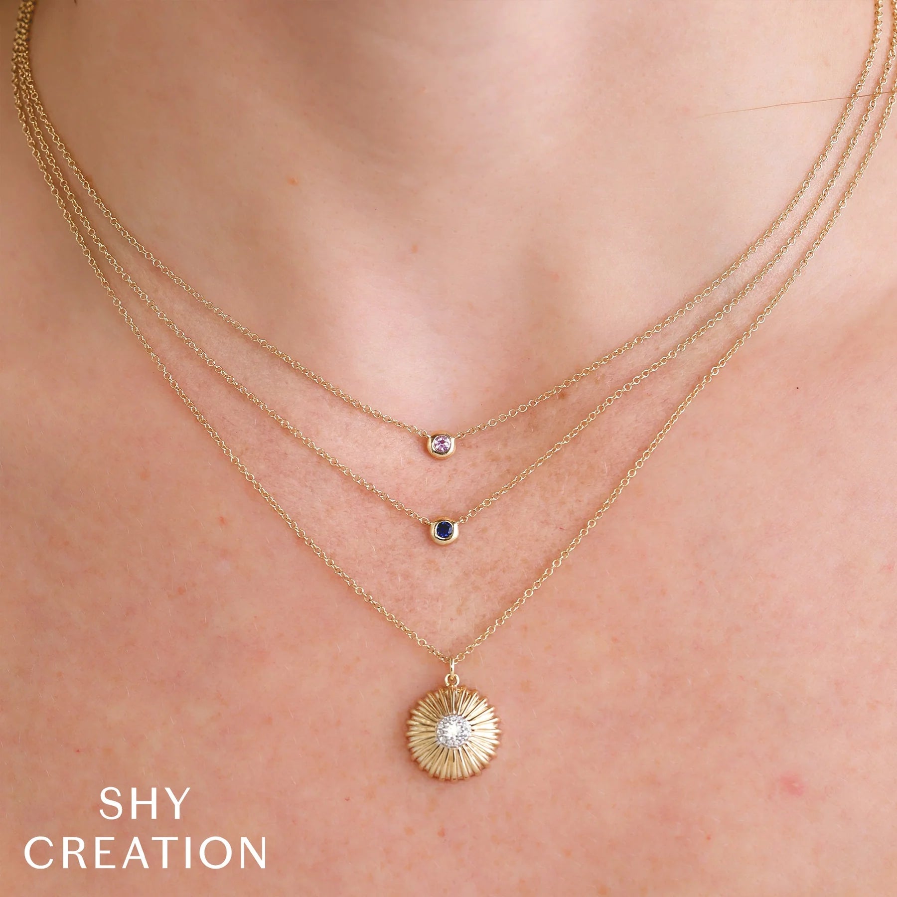 Yellow gold blue sapphire bezel pendant necklace