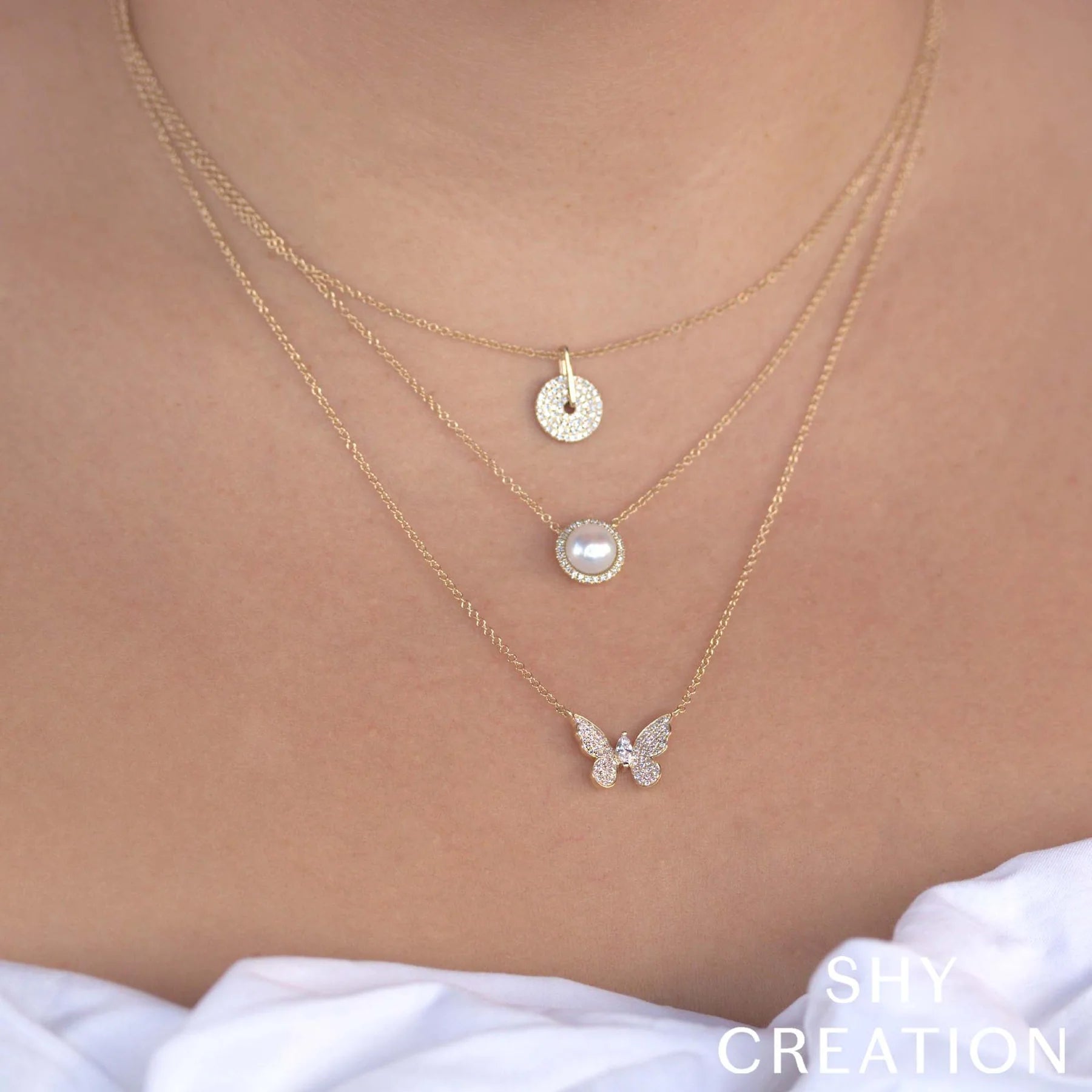 Woman wearing white gold diamond butterfly pendant