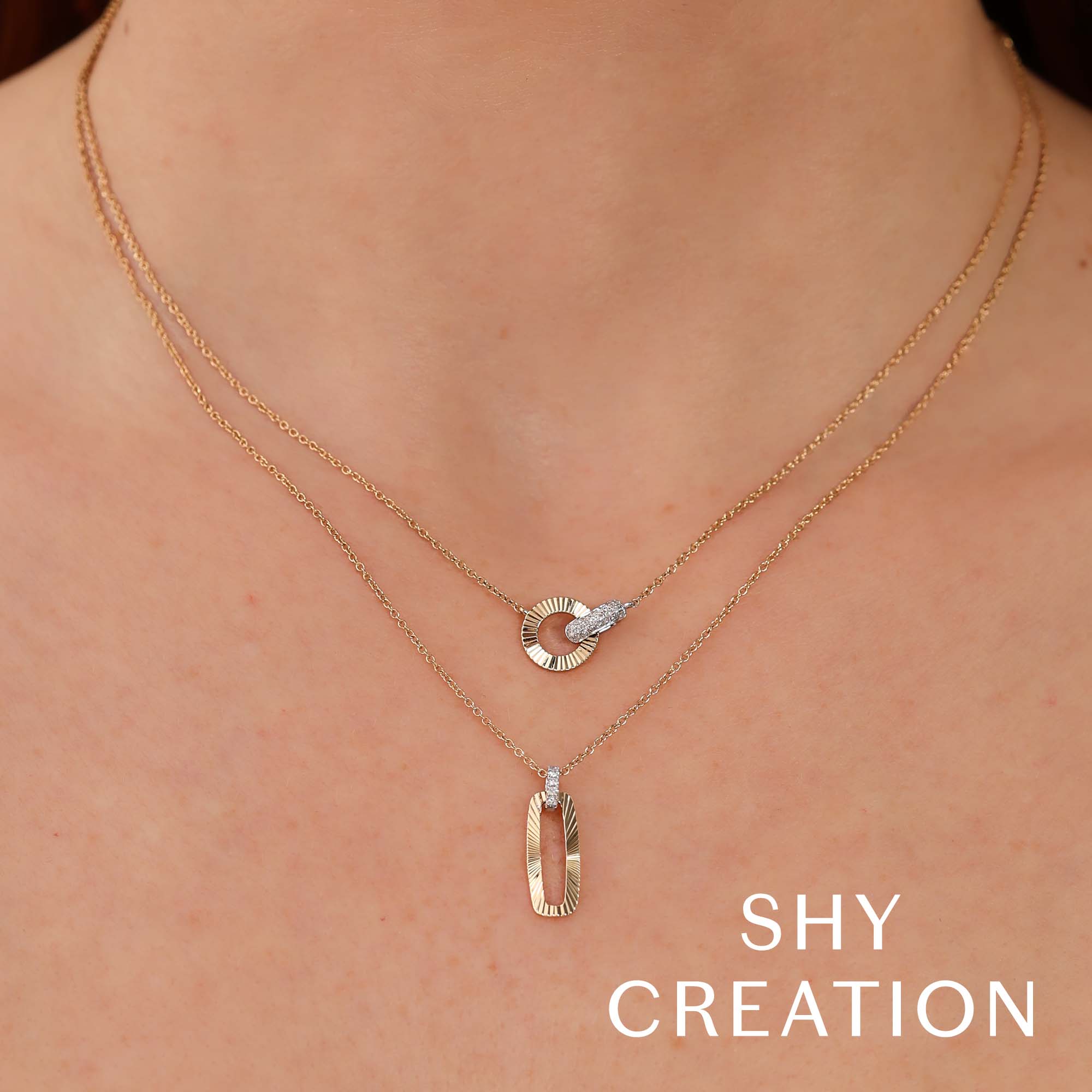 Woman wearing white and yellow gold diamond necklace with circular pendant, front view