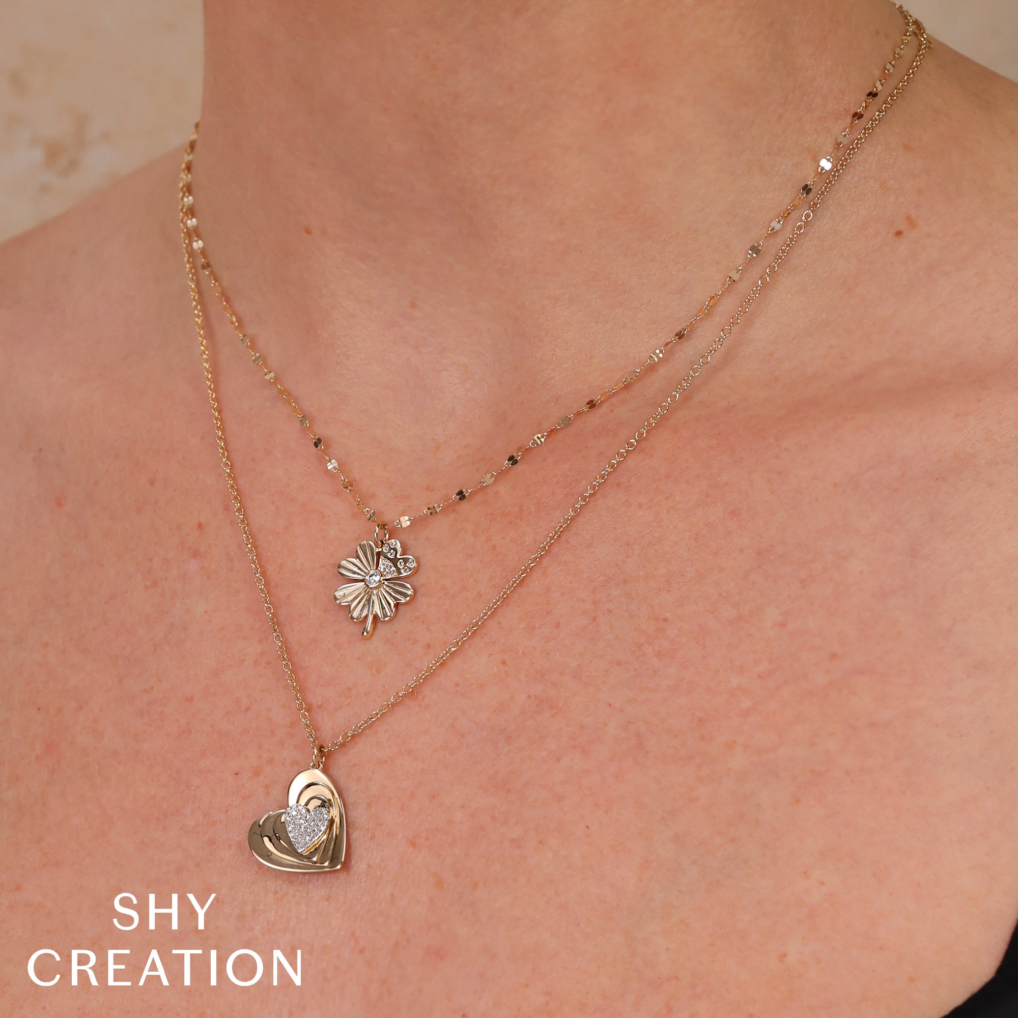 Woman wearing yellow gold diamond clover pendant necklace
