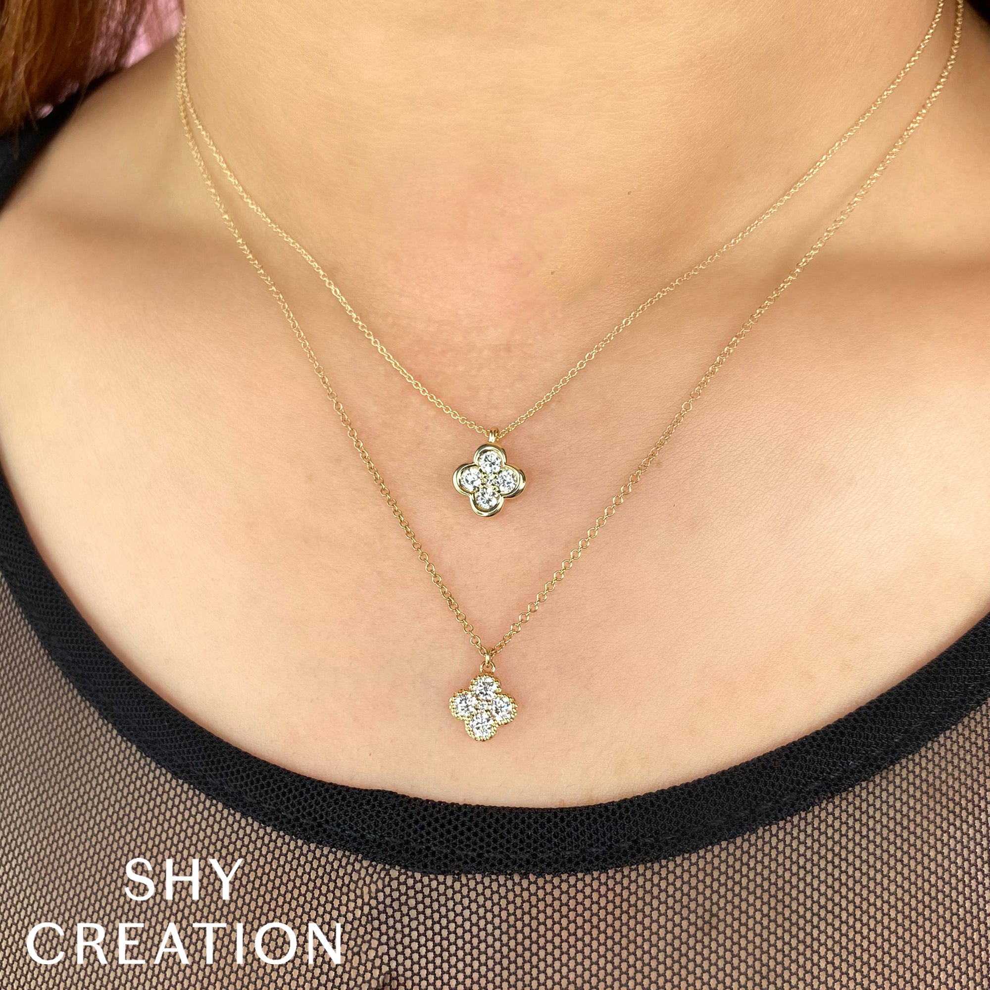 Woman wearing yellow gold diamond clover pendant necklace