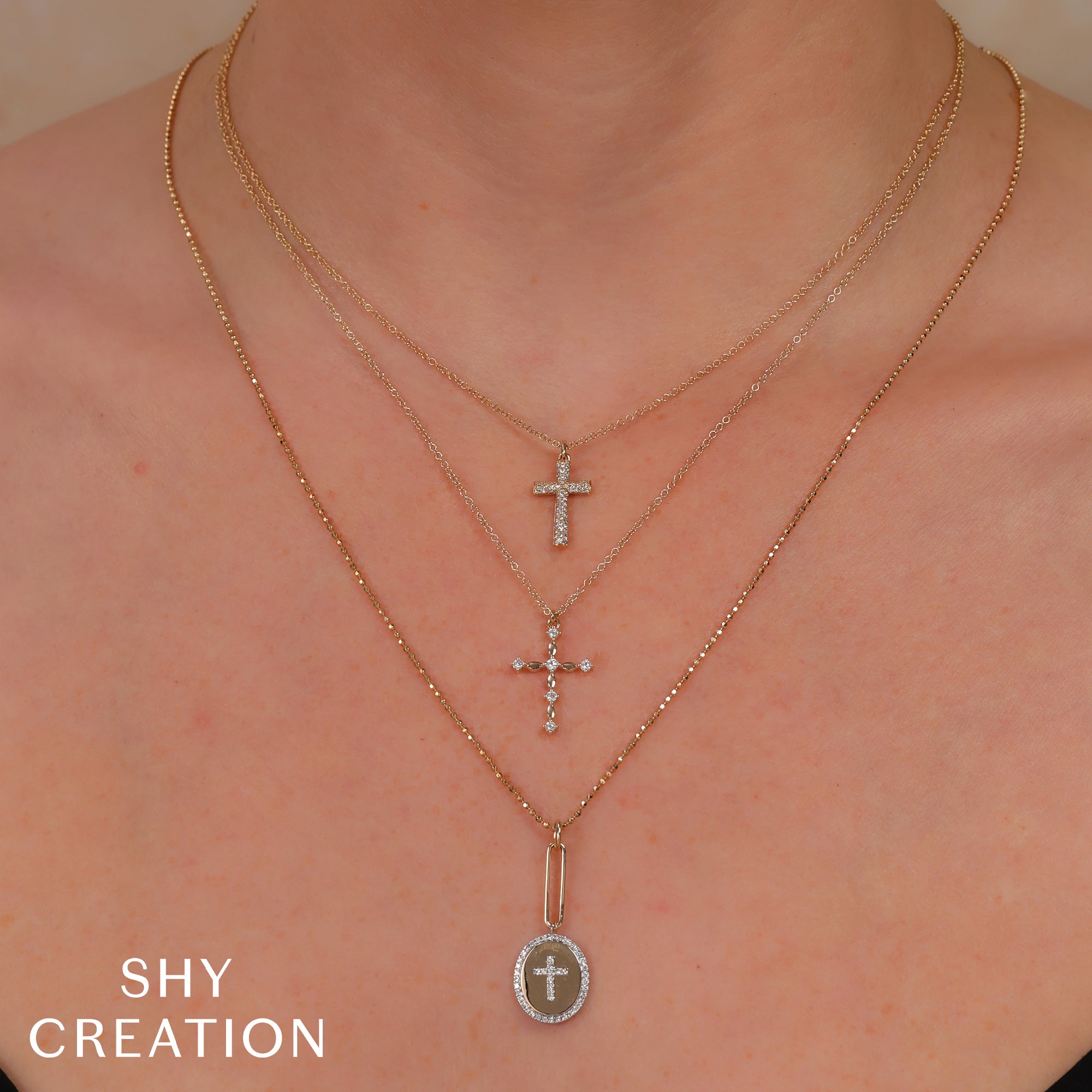 Woman wearing yellow old diamond cross necklace