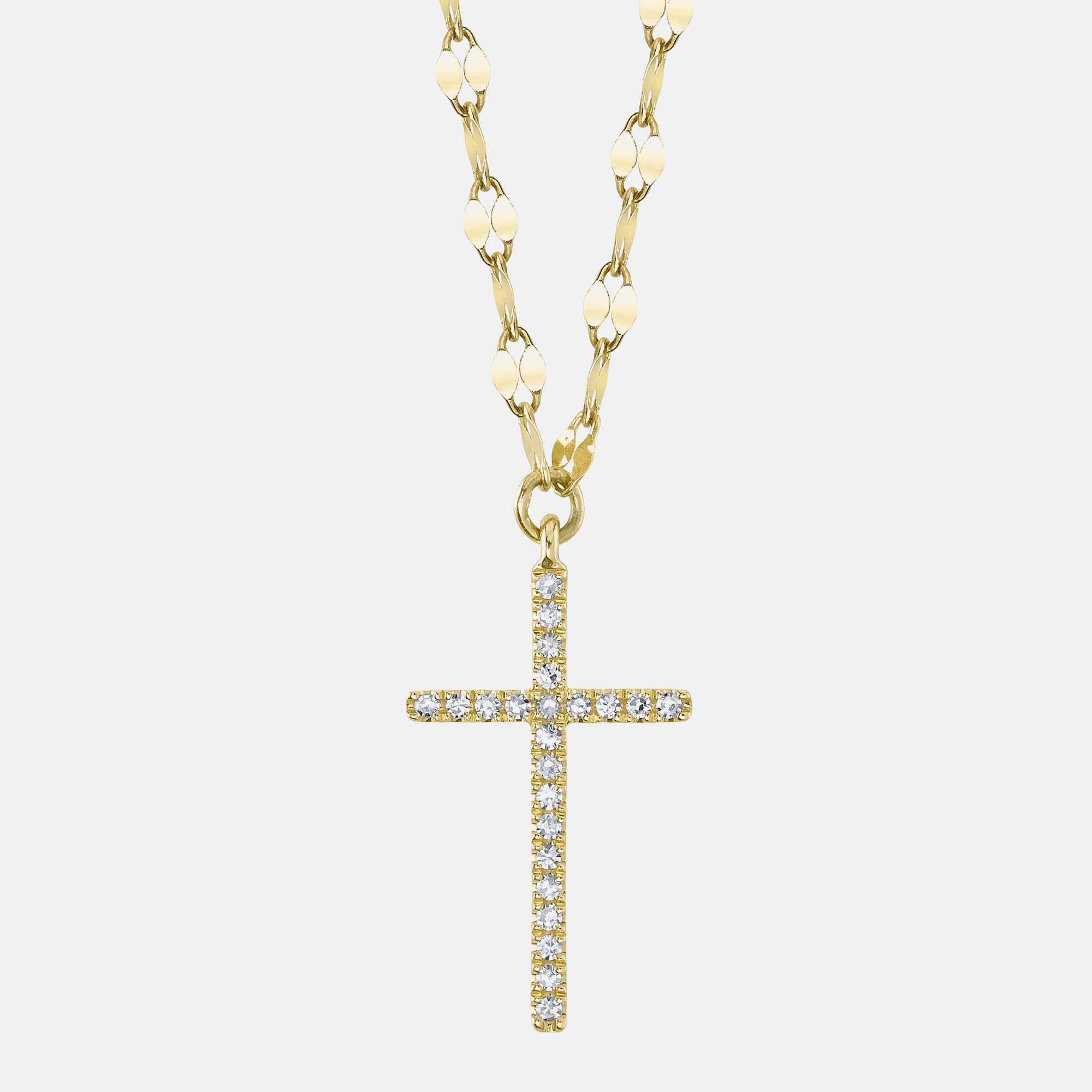 Gold necklace with a diamond cross pendant on a light gray background