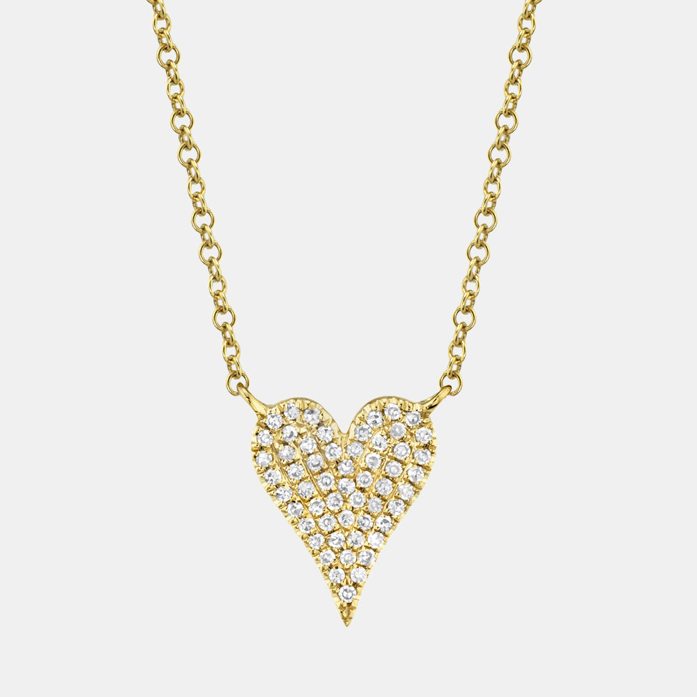 Gold heart-shaped necklace with diamond accents on a light gray background
