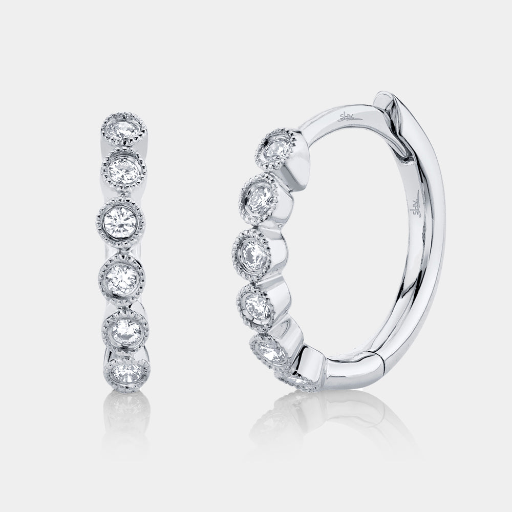 White gold diamond huggie earrings, front angle view
