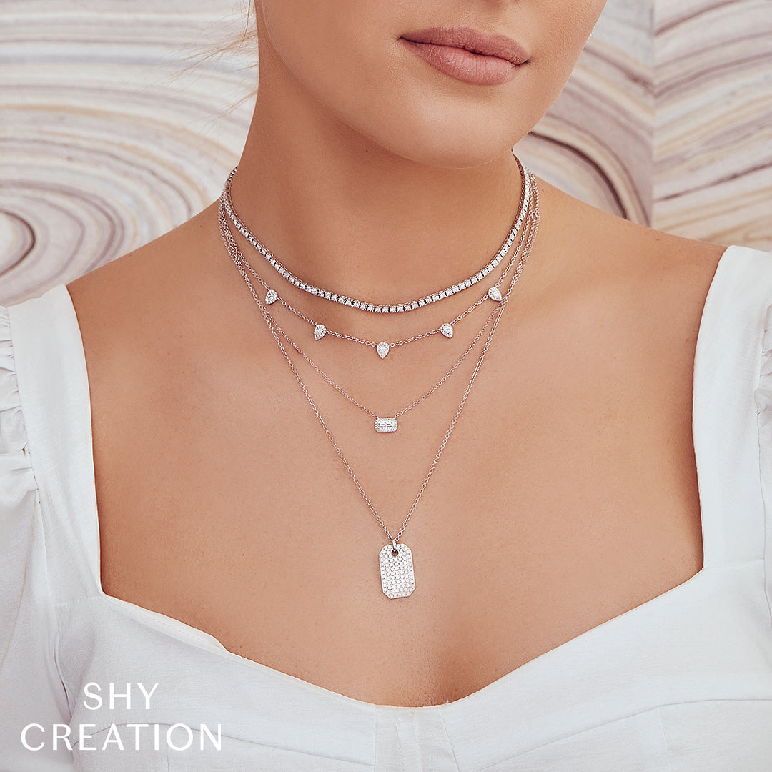 Woman wearing white gold diamond tennis necklace