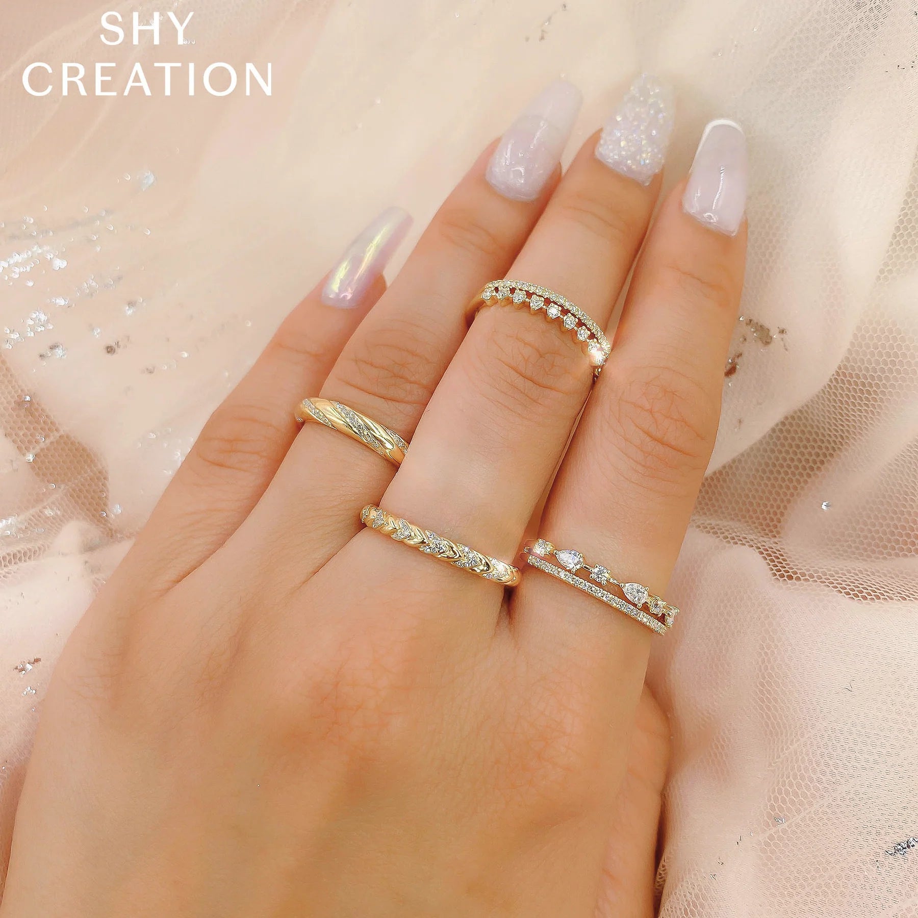 Woman's hand wearing white gold pear shaped diamond two row fashion ring