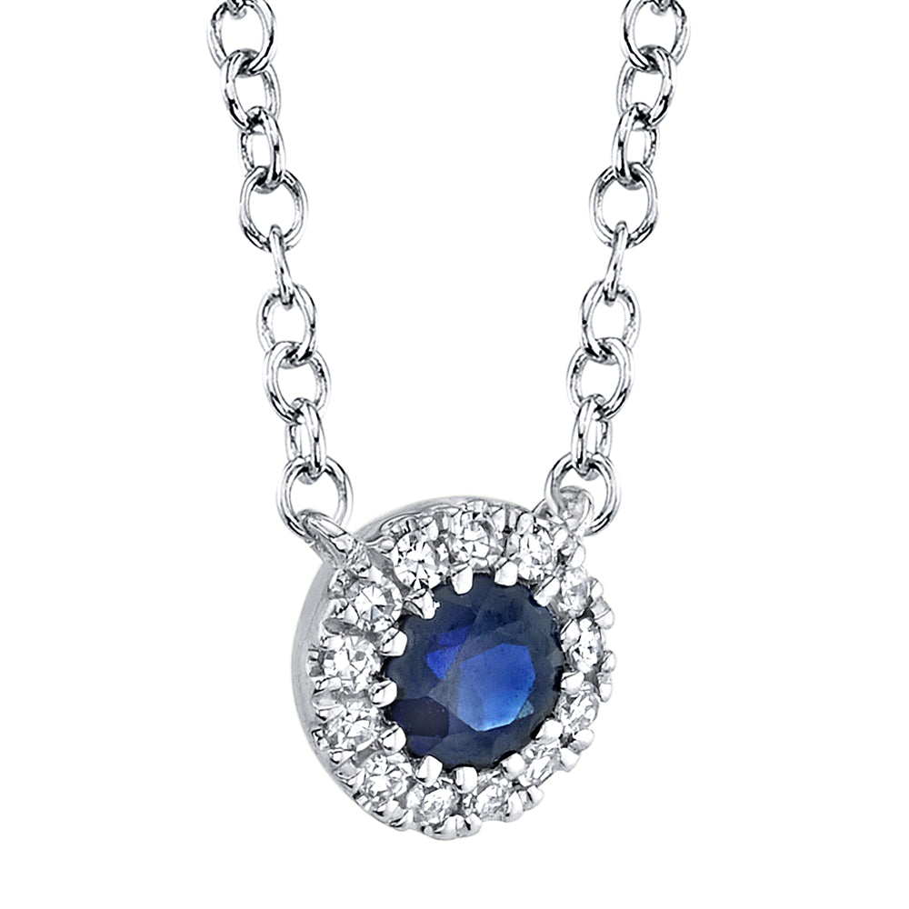 White gold necklace with a blue sapphire pendant on a white background