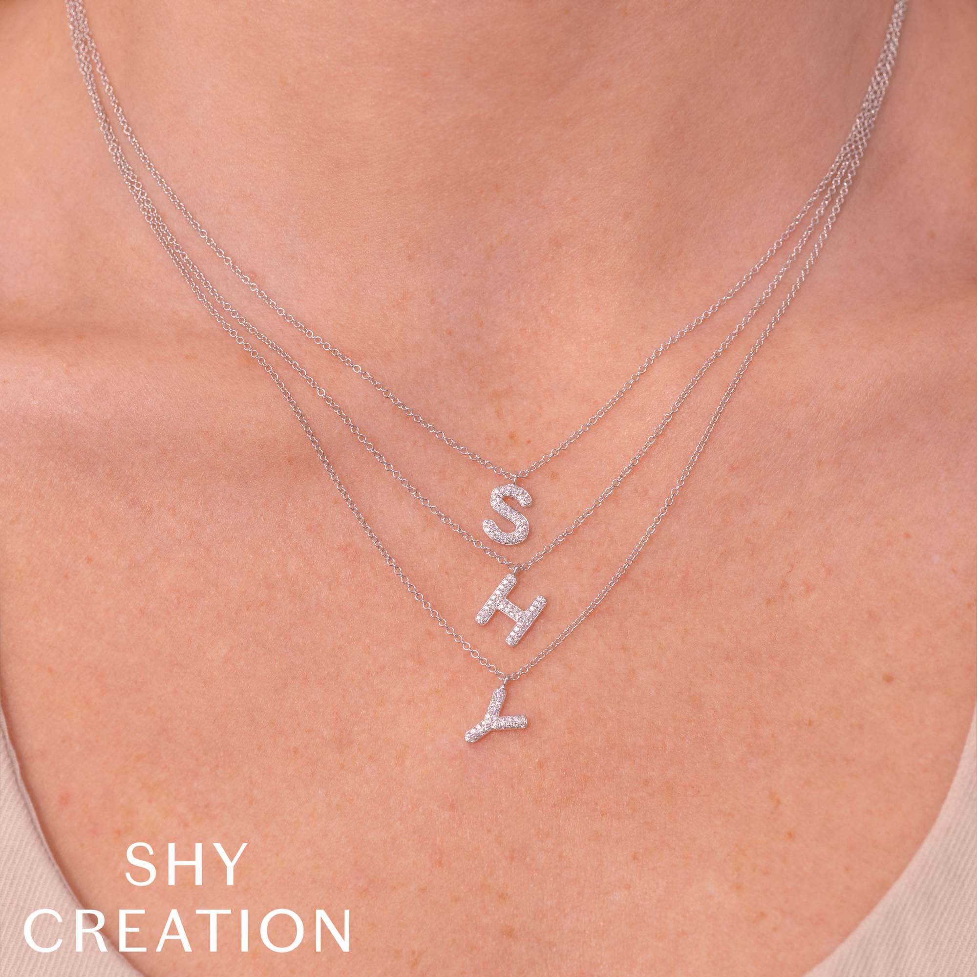 Women wearing white gold diamond letter s initial pendant necklace