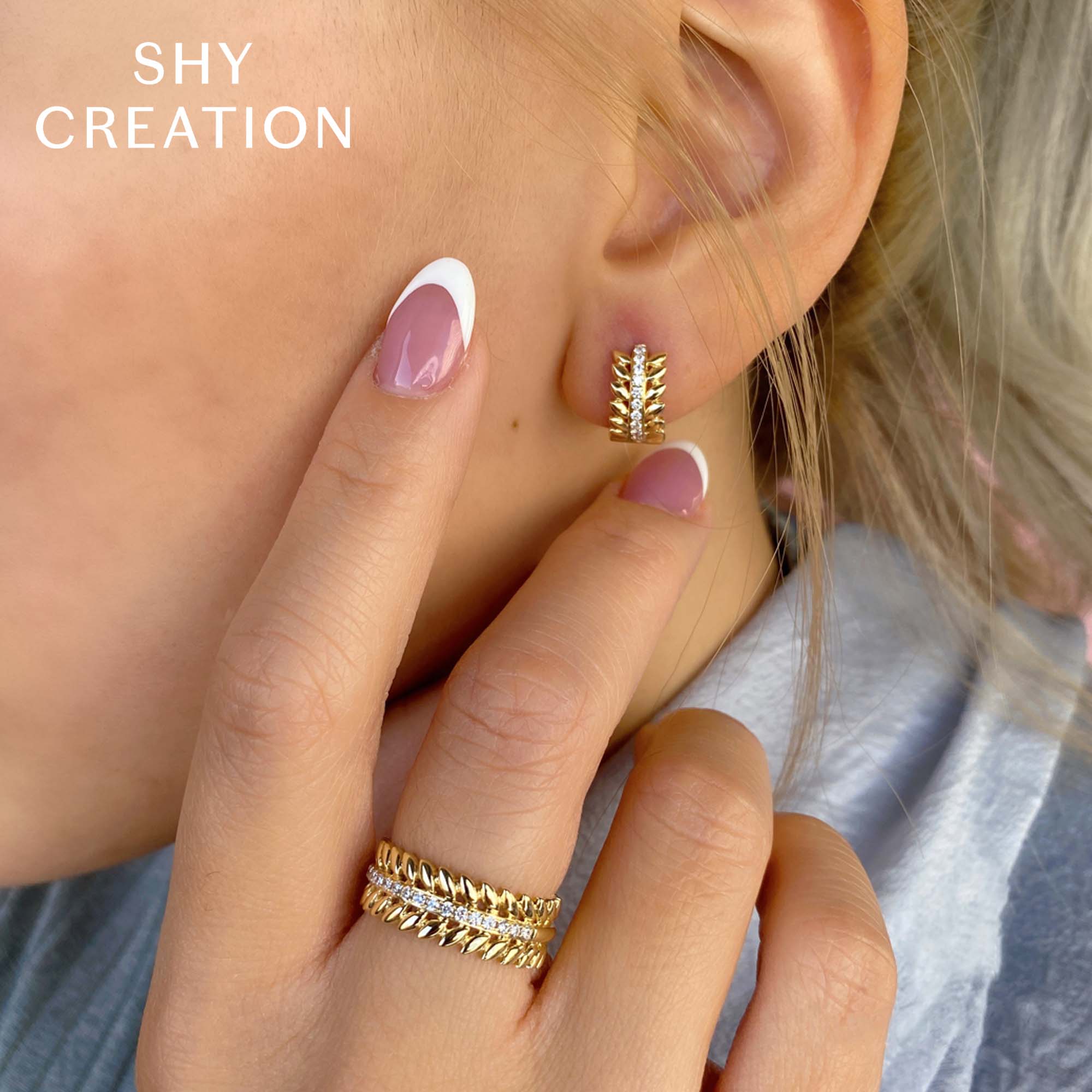 Woman wearing yellow gold diamond wreath huggie earrings