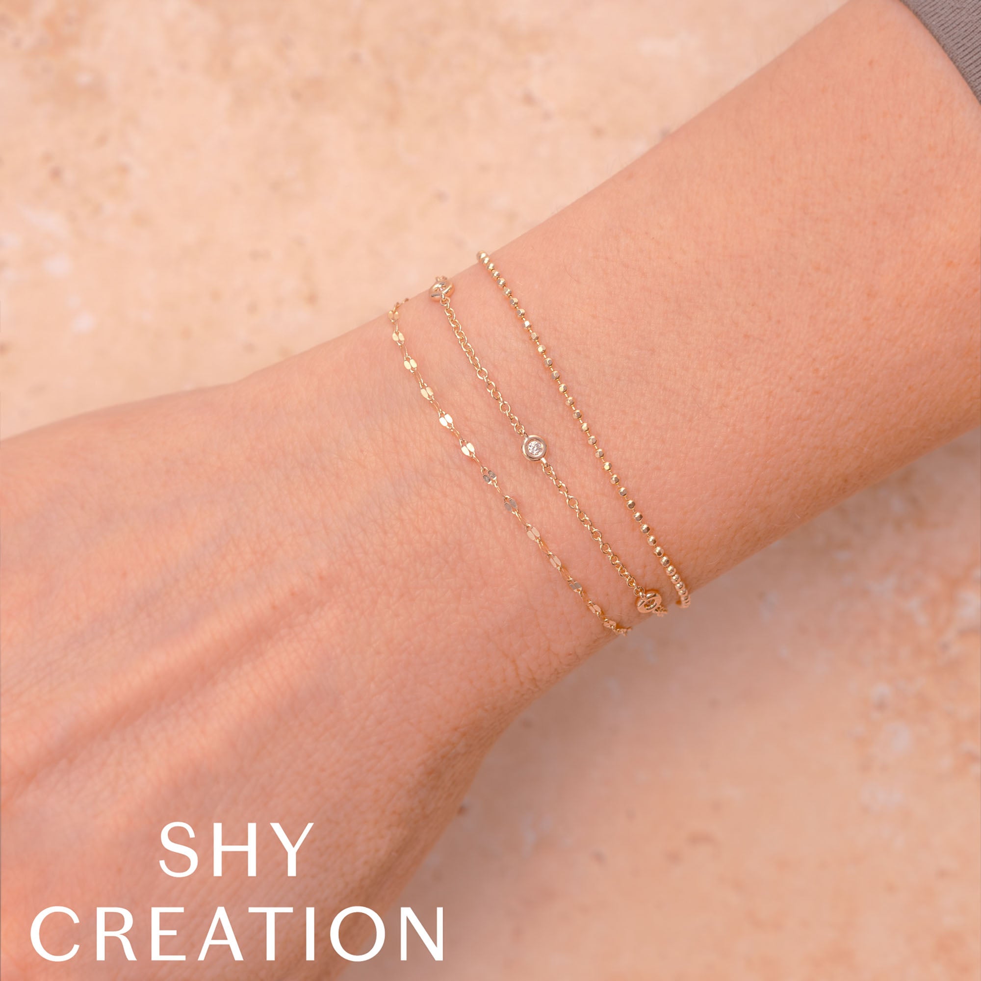 Woman wearing yellow gold diamonds by the yard bracelet