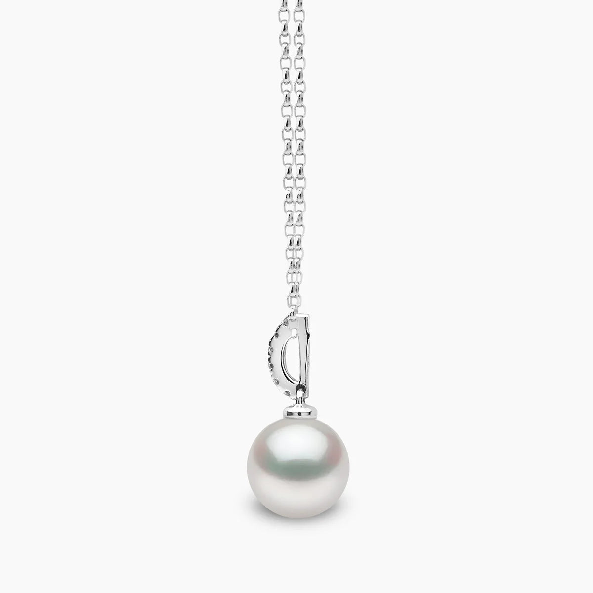 White gold cable chain necklace with pearl pendant featuring diamond accents, side view