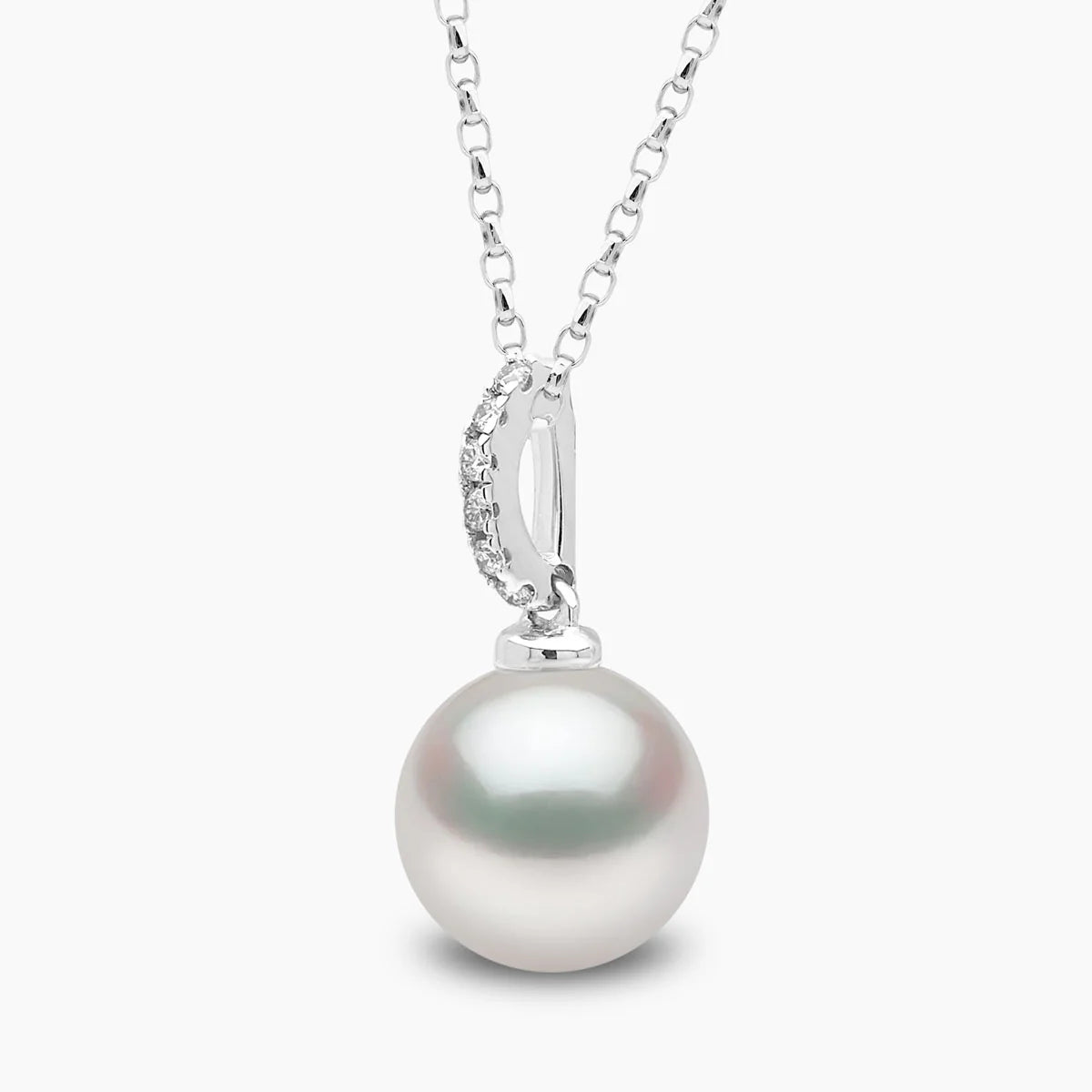 White gold cable chain necklace with pearl pendant featuring diamond accents, closeup side angle