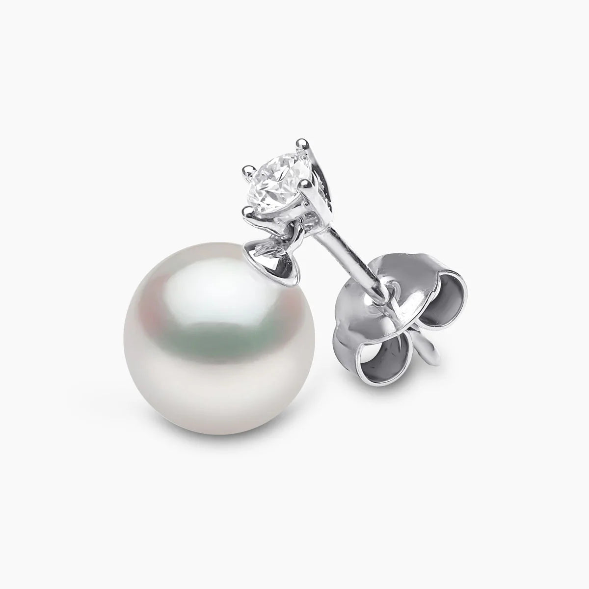 White gold pearl and diamond drop earringon grey backgroun