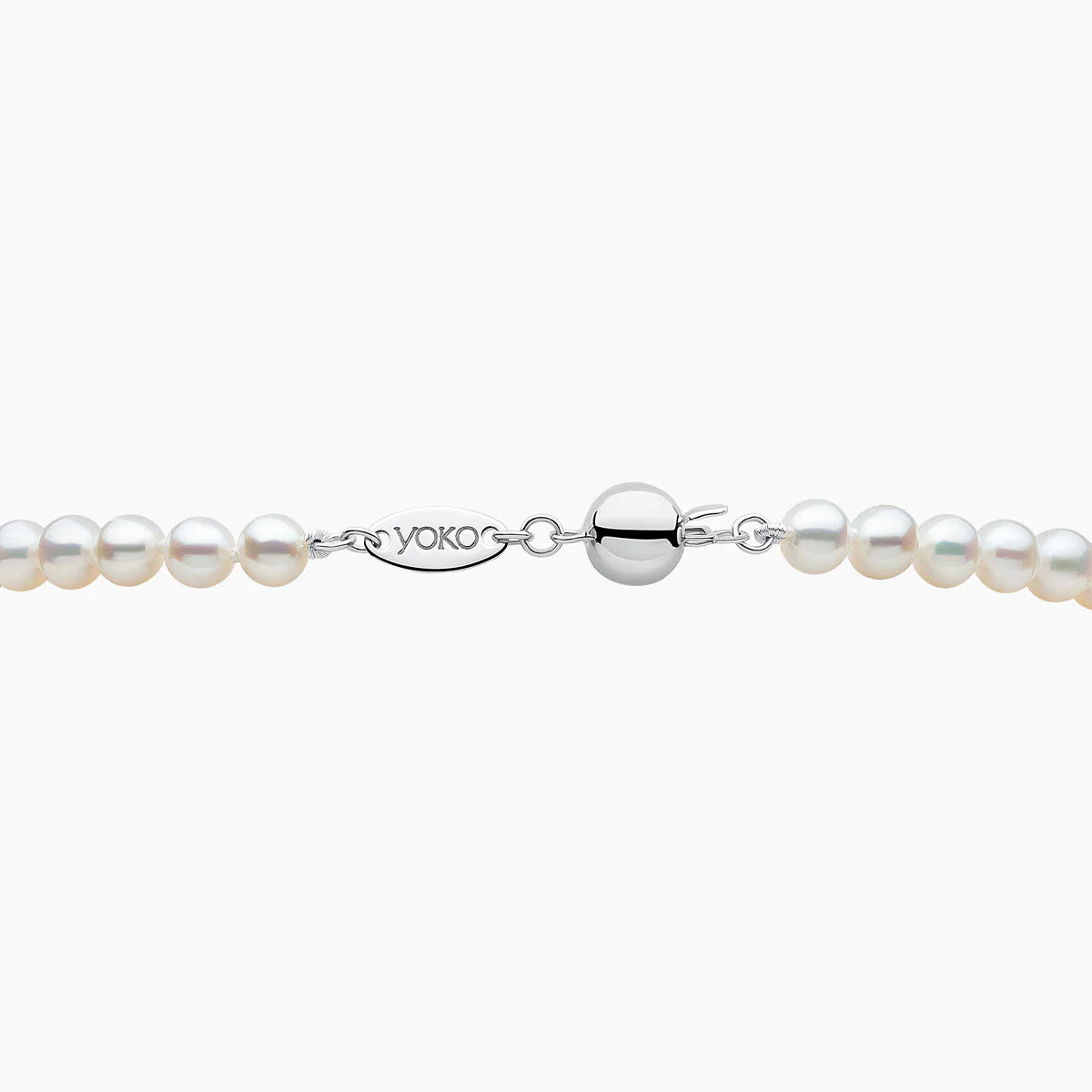 Pearl necklace with silver clasp on a white background, featuring the Yoko London brand.