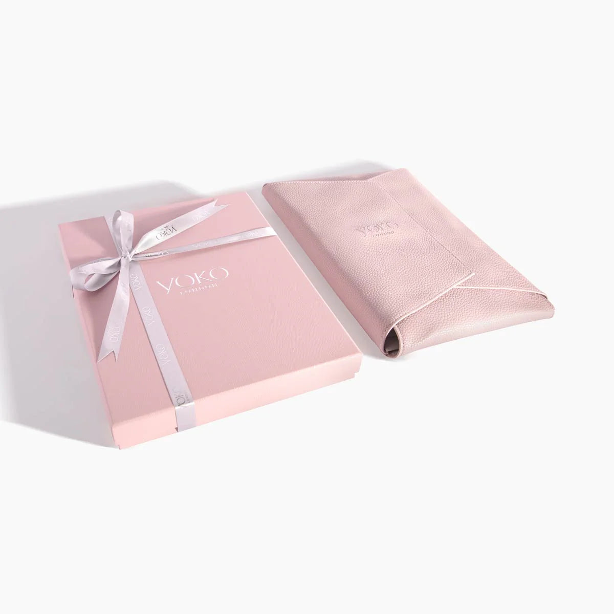 Pink gift box with a bow and 'Yoko' branding on a white background