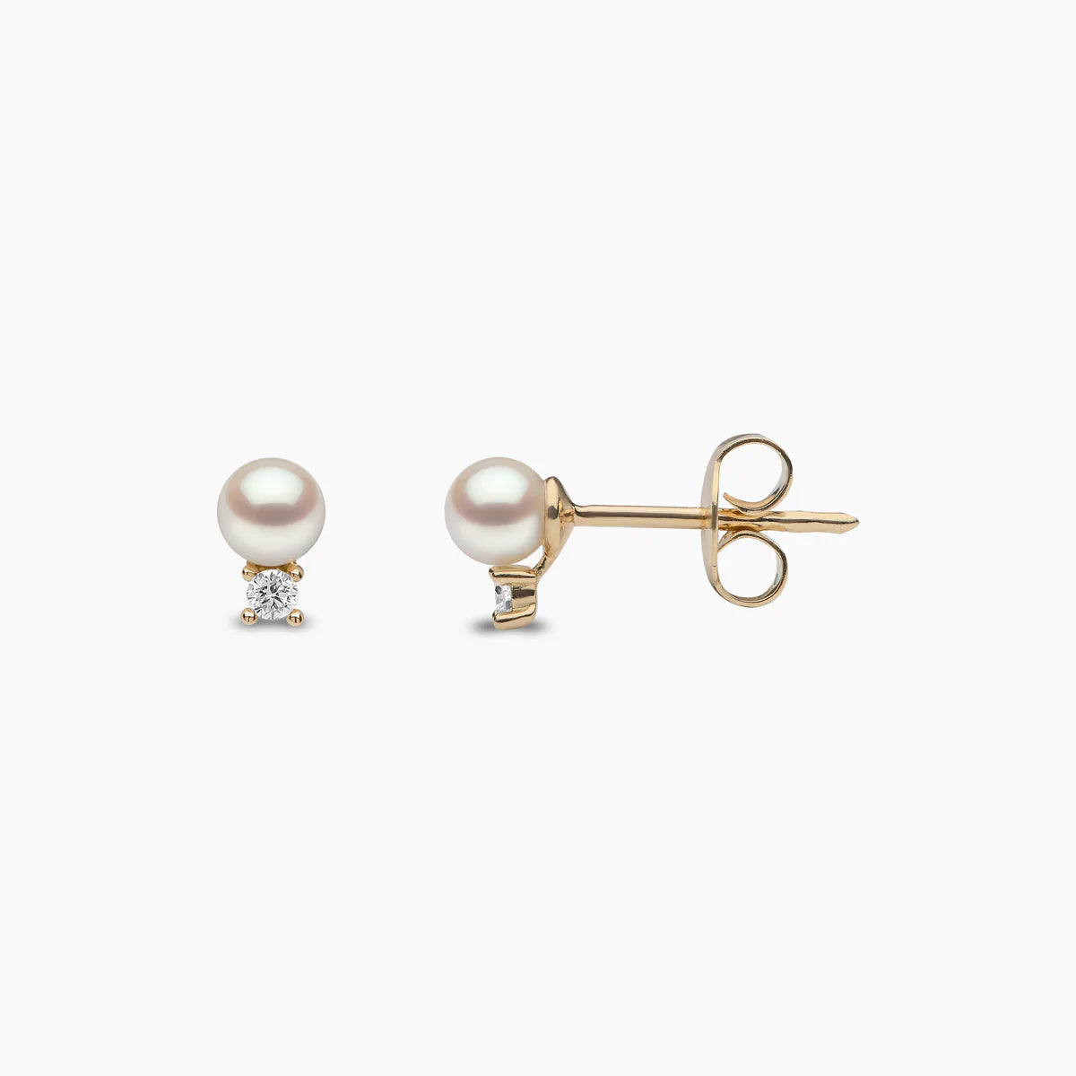 White pearl stud earrings with diamond accents, front and side view
