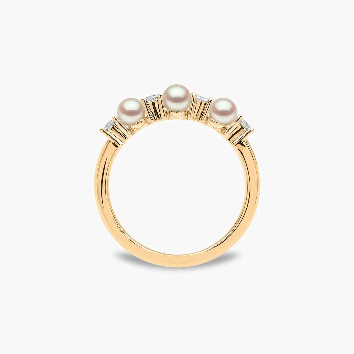 Yellow gold pearl and diamond ring on grey background, front upright view